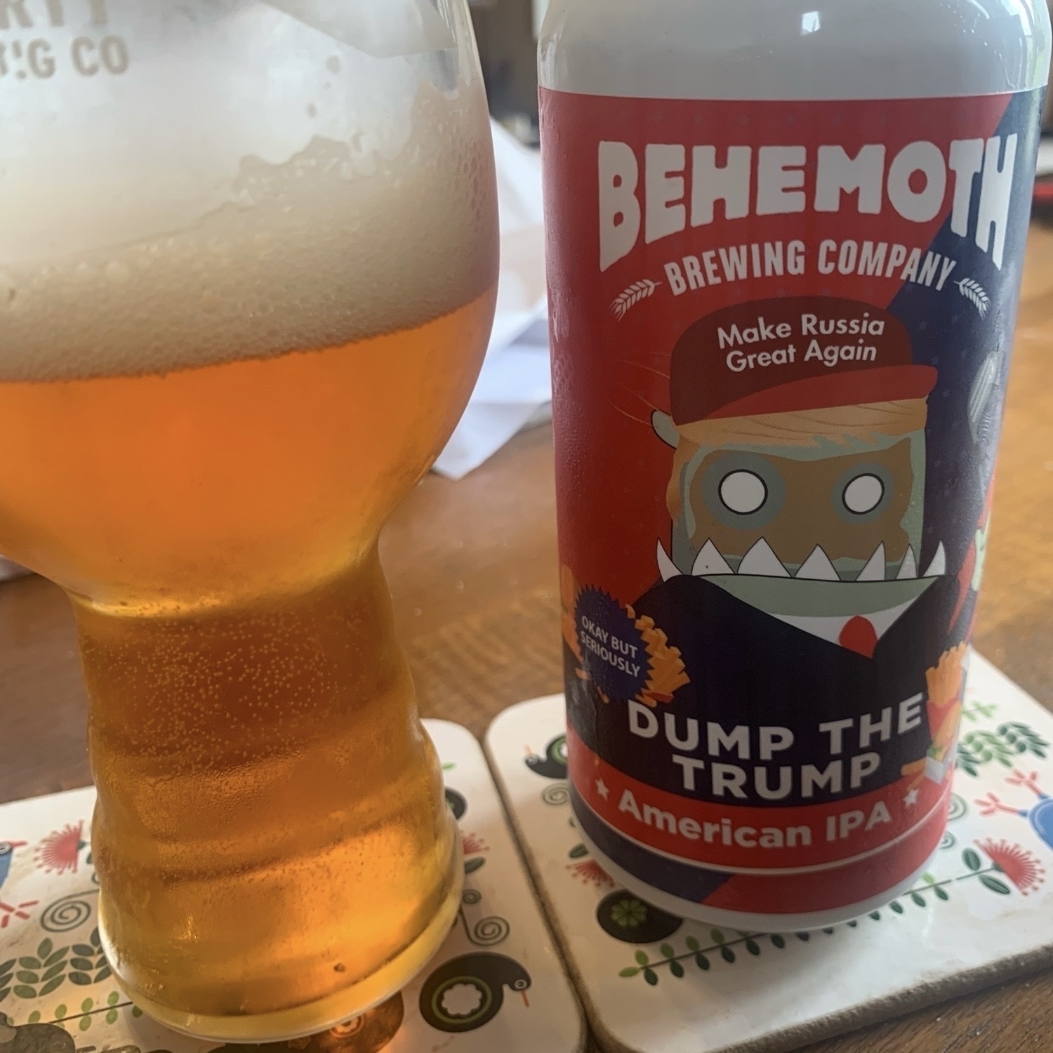 A glass and a can of Dump the Trump American IPA by Behemoth Brewing