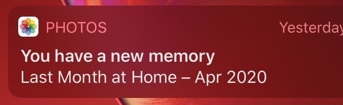 a notification from Apple Photos app saying 'you uave a new memory: last month at home'