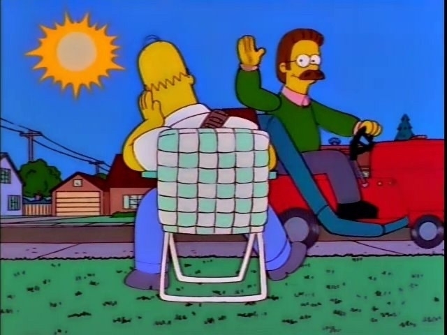 A screenshot from The Simpsons, with Homer waiting impatiently on his lawn.