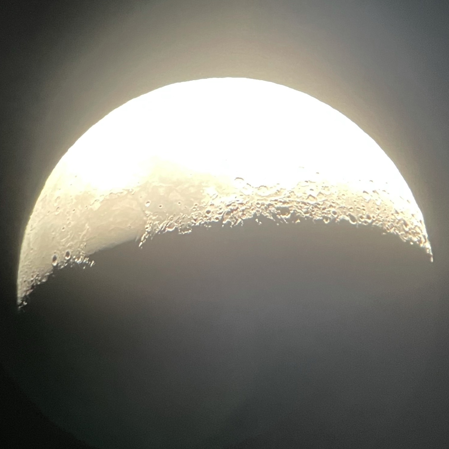 The moon, in epic detail through a telescope. The teleif of the sirface features are stark and the detail in the relief of surface features make it look loke you could run your fingers along the sueface. 