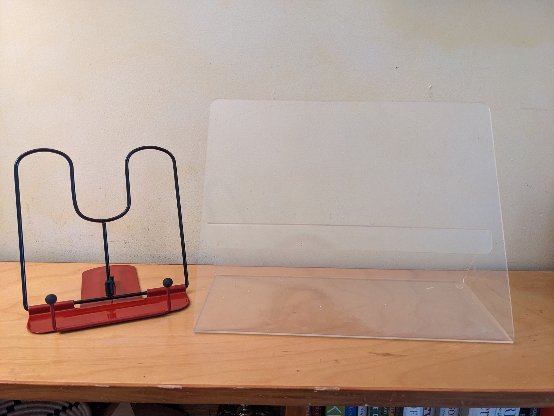 folding book holder for typing, on a shelf next to large acrylic cookbook holder