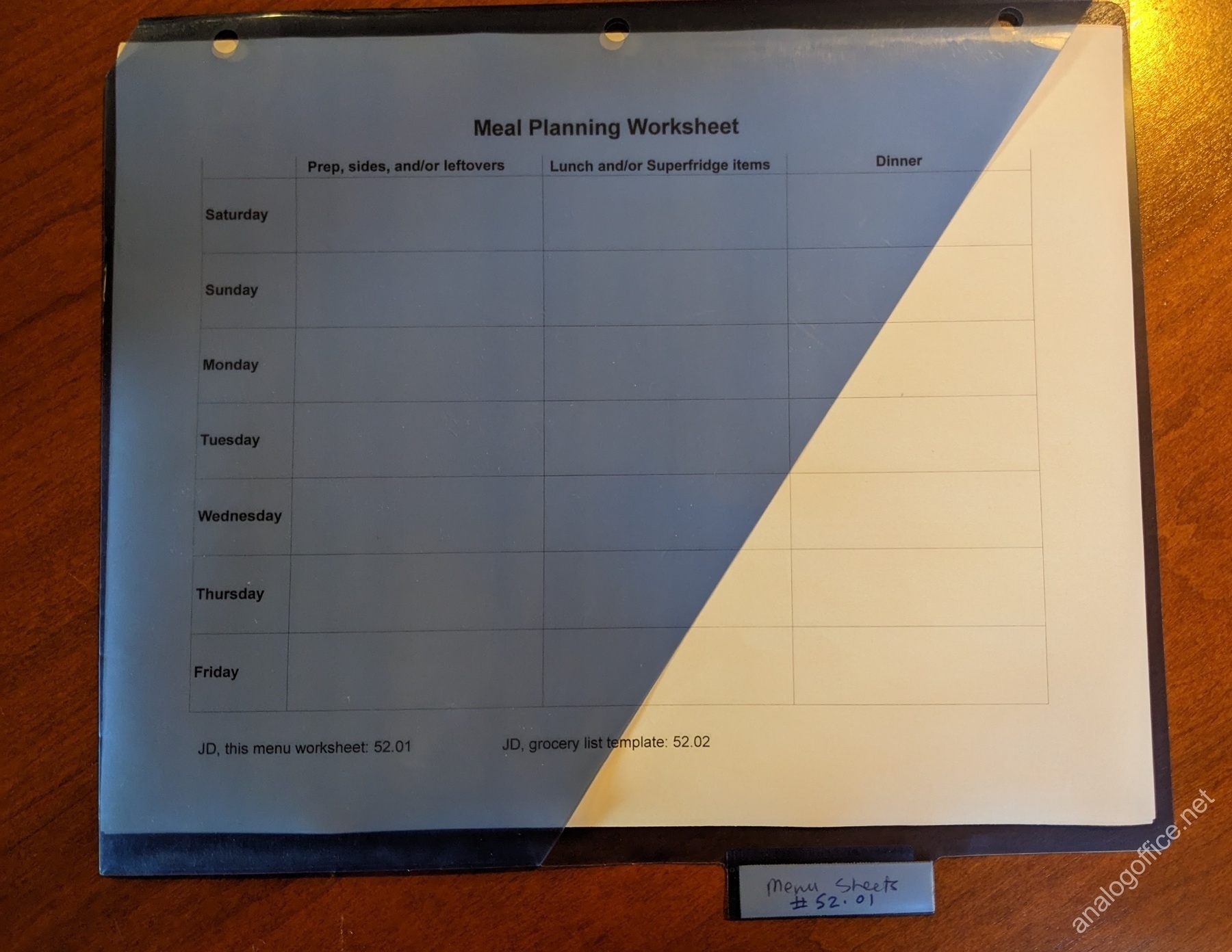 menu sheet in a binder tab folder, with the Johnny.Decimal number for the menu document in the binder tab slot