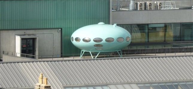 A Futuro House, looking like a flying saucer on the roof of a building