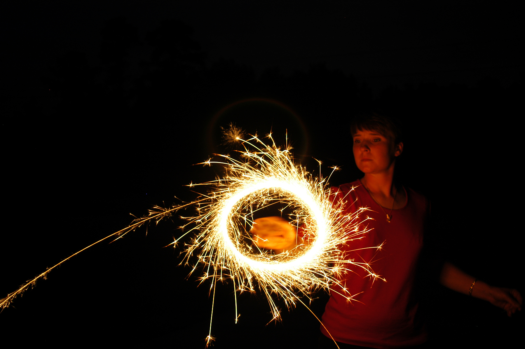 Twirling Sparks of a Sparkler at Night