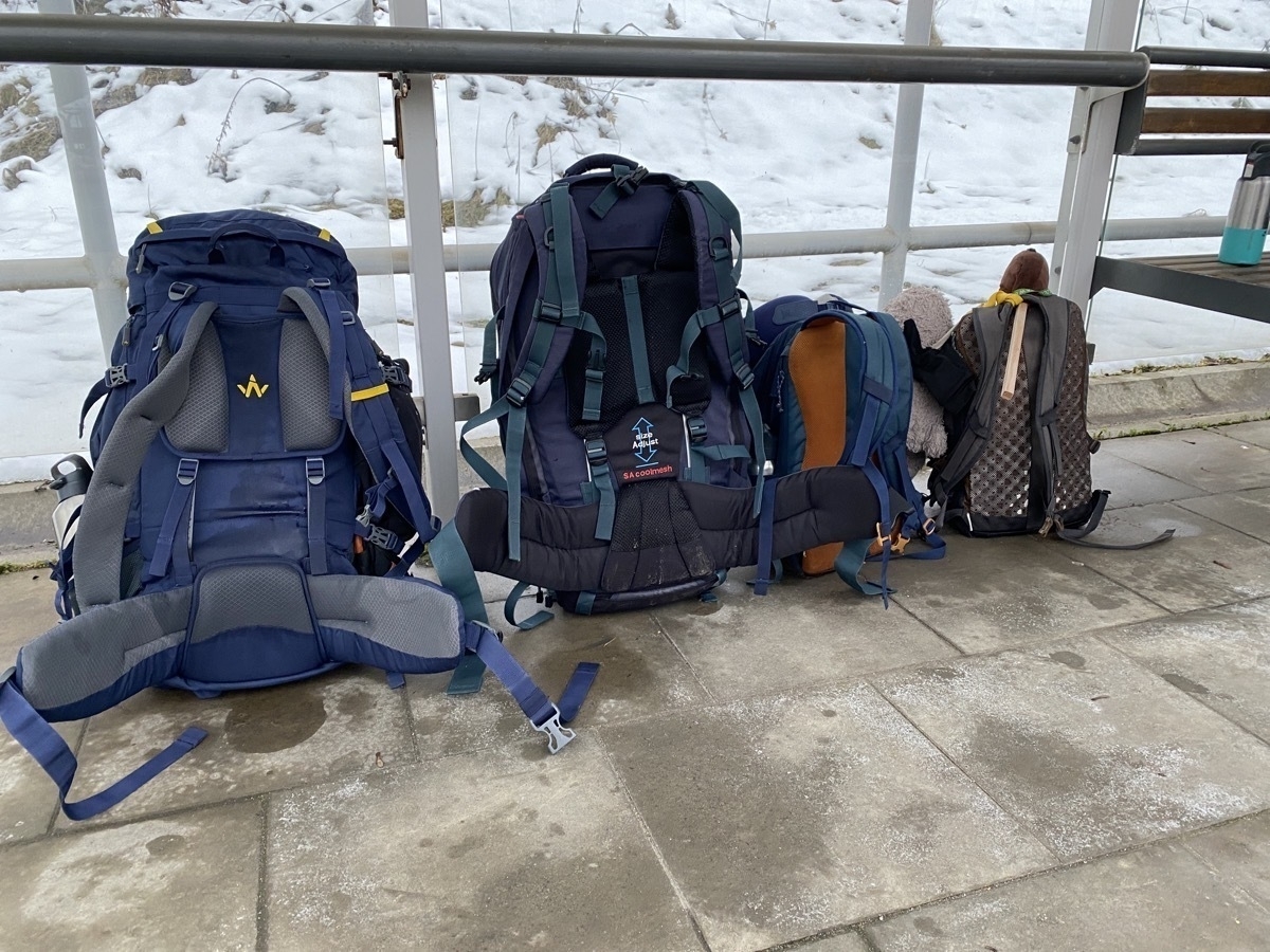 Four backpacks at the last bus stop