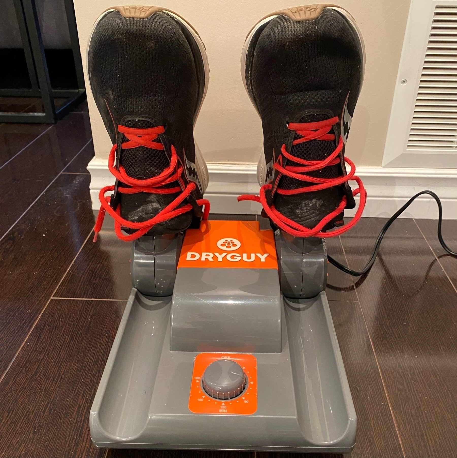 pair of running shoes drying on a shoe dryer