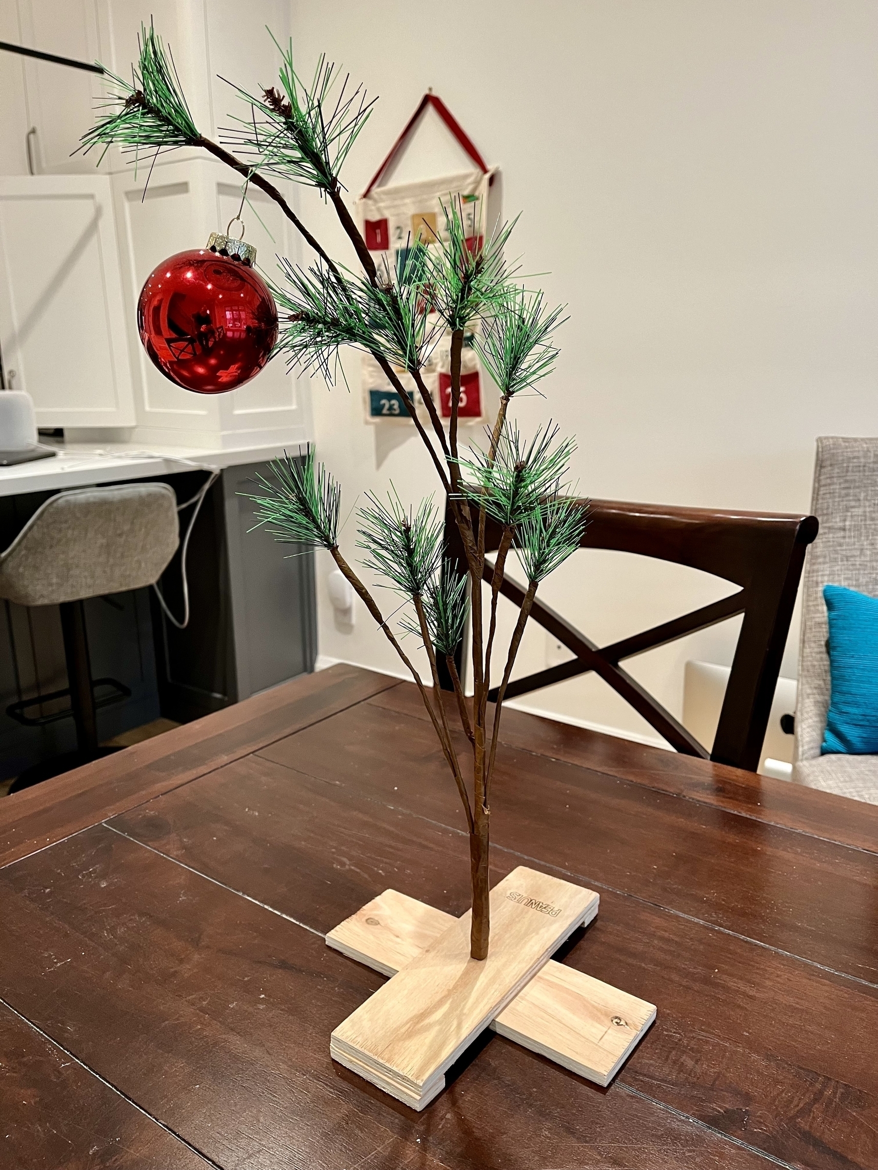 Charlie Brown novelty tree. Very spindly with a single drooping ornament