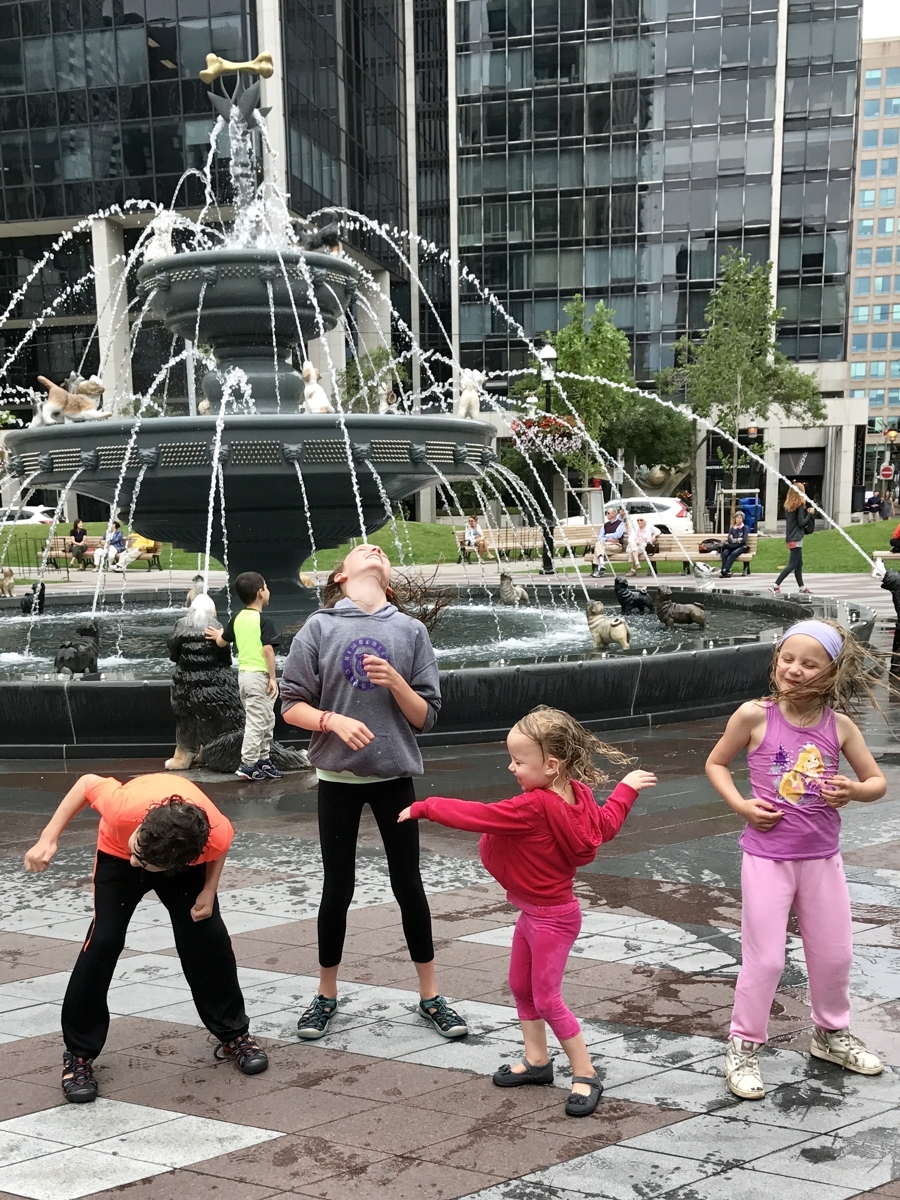 Kids getting soaked by a fountain