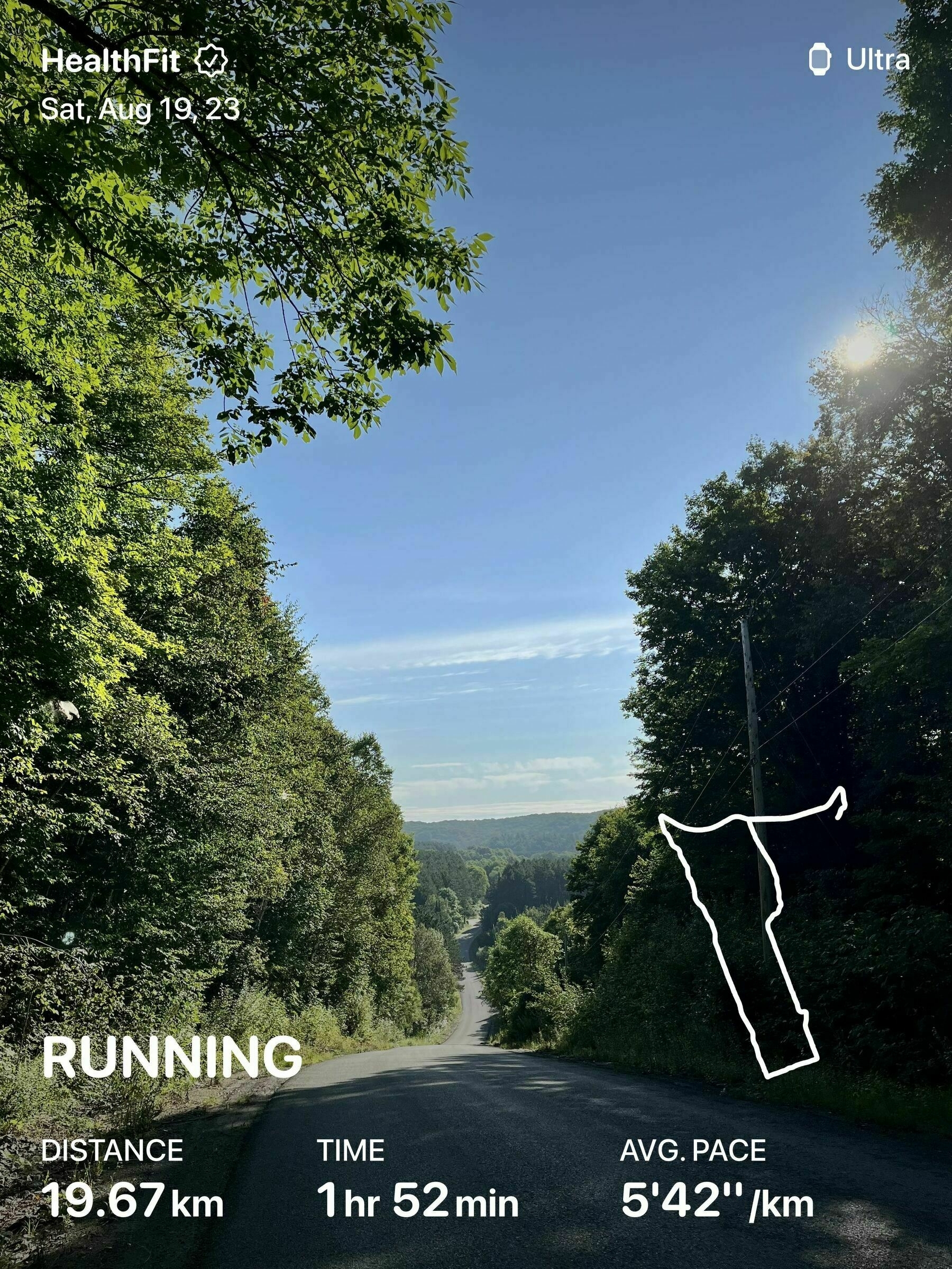 Gravel road through hills with running stats overlaid: 19.67km; 1hr52m