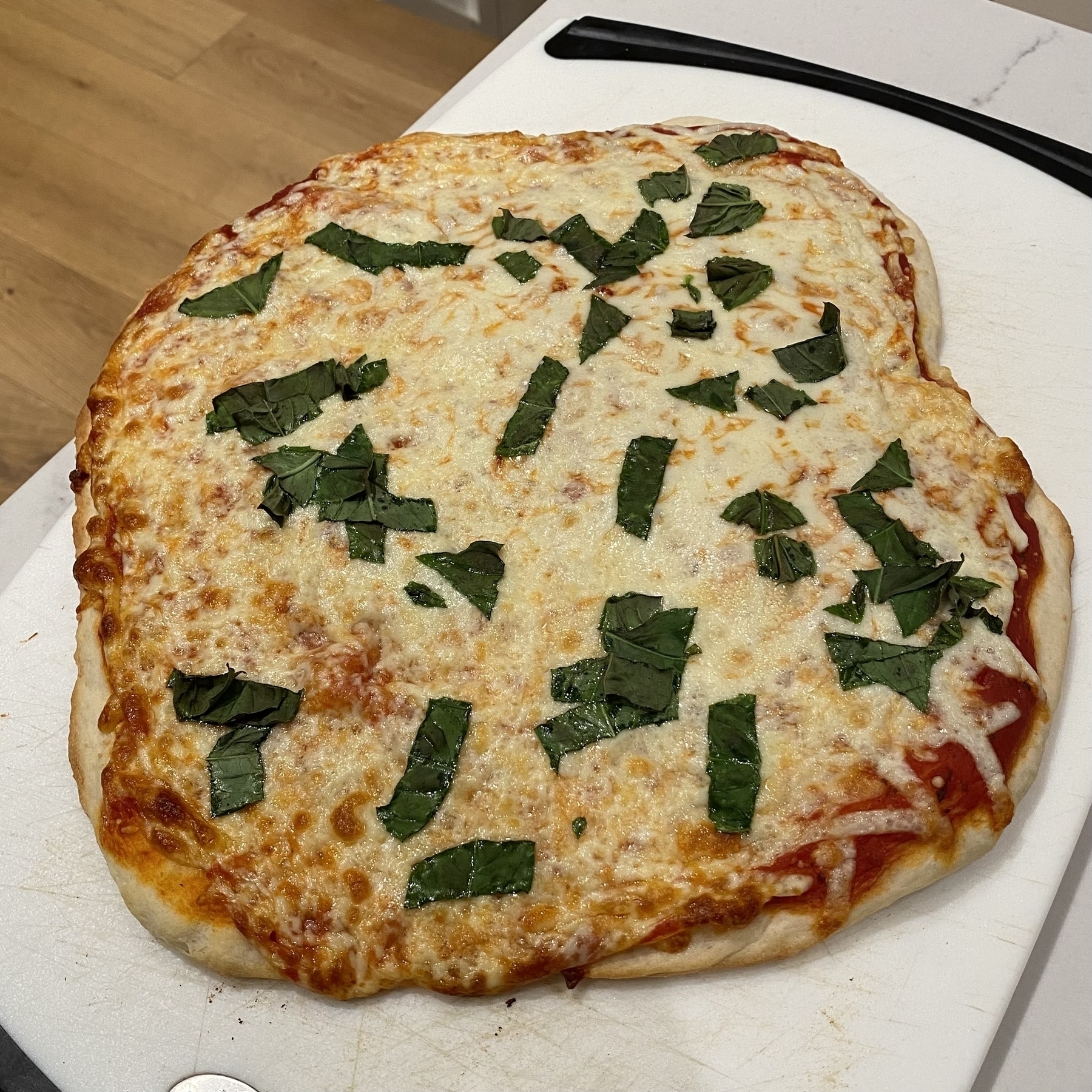 Homemade pizza in the sort of shape of a square