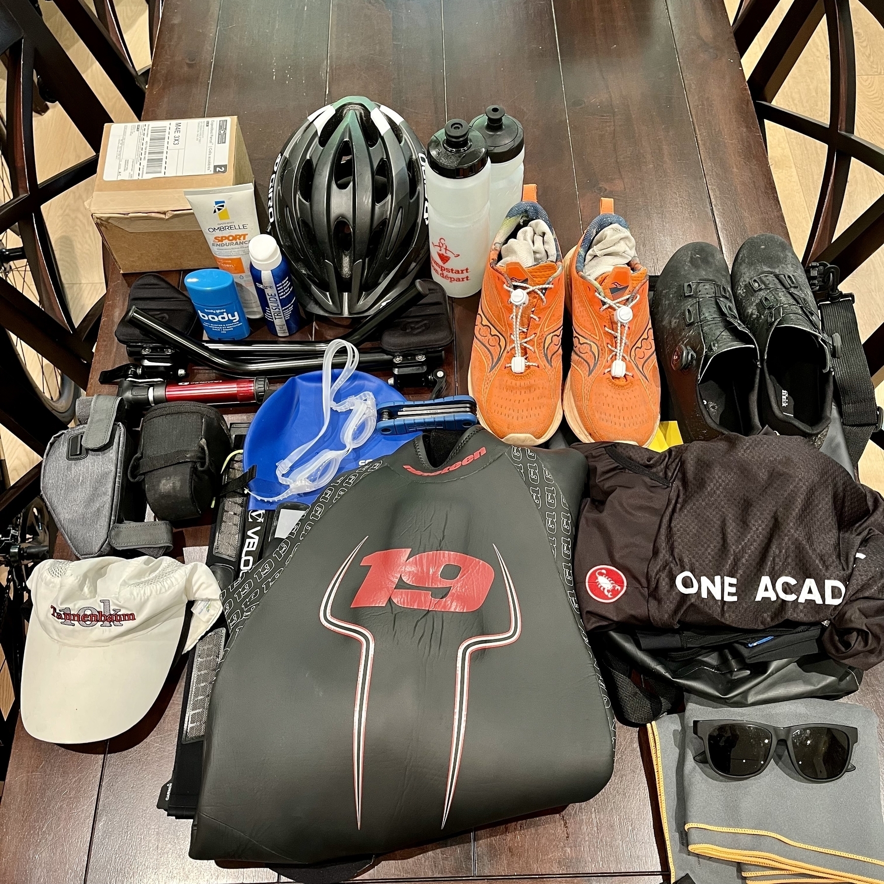 Table piled with triathlon gear for packing 