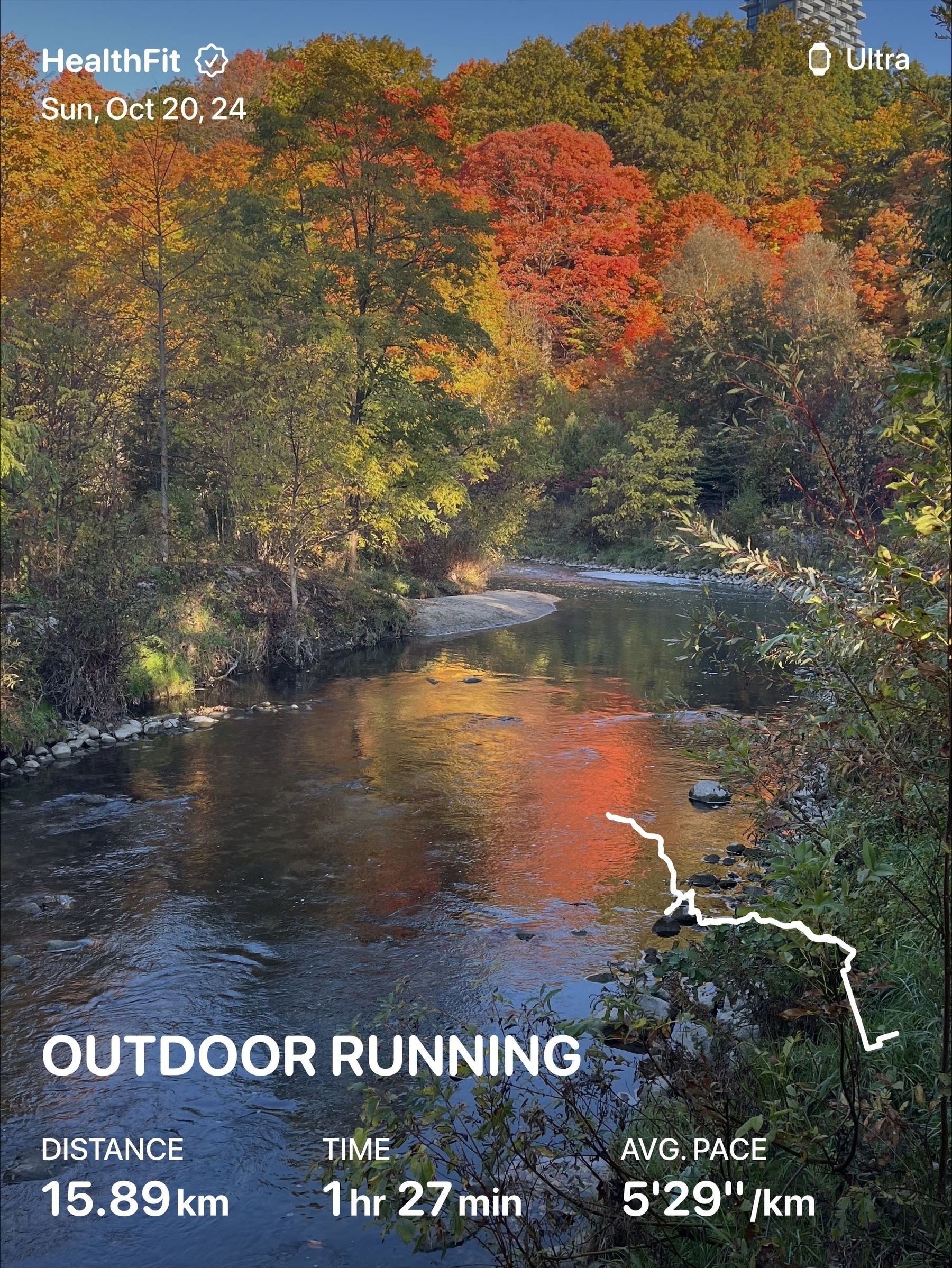 A picturesque autumn landscape features a serene river surrounded by colorful foliage, with running metrics displayed overlaying the scene.