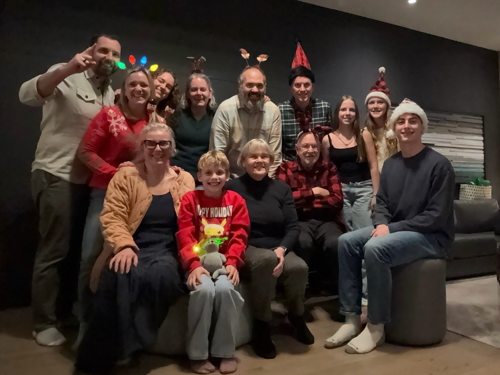 Family group shot with many wearing Christmas hats