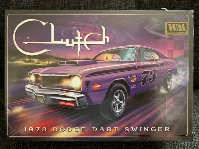 A box displays artwork of a purple 1973 Dodge Dart Swinger model kit with stylized writing and colorful graphics.