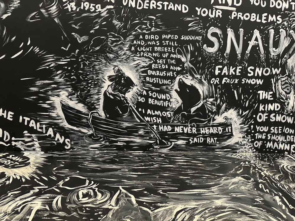 A chalk drawing on a black wall and floor depicts a scene with two animals in a boat accompanied by text.