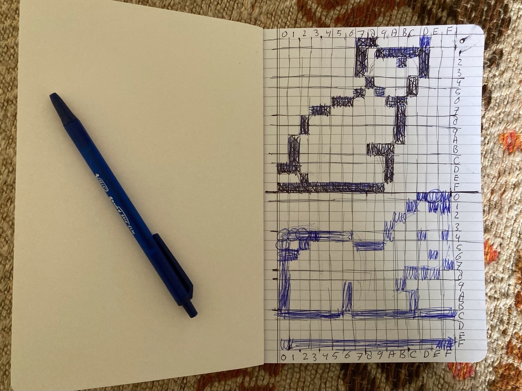 Notebook page with initial pixel art sketches