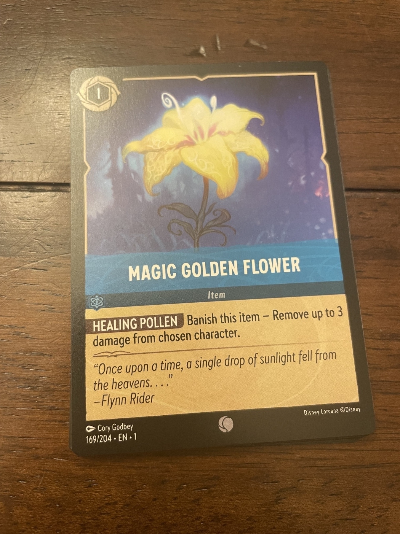 Picture of the “Magic Golden Flower” card from Disney’s Lorcana trading card game
