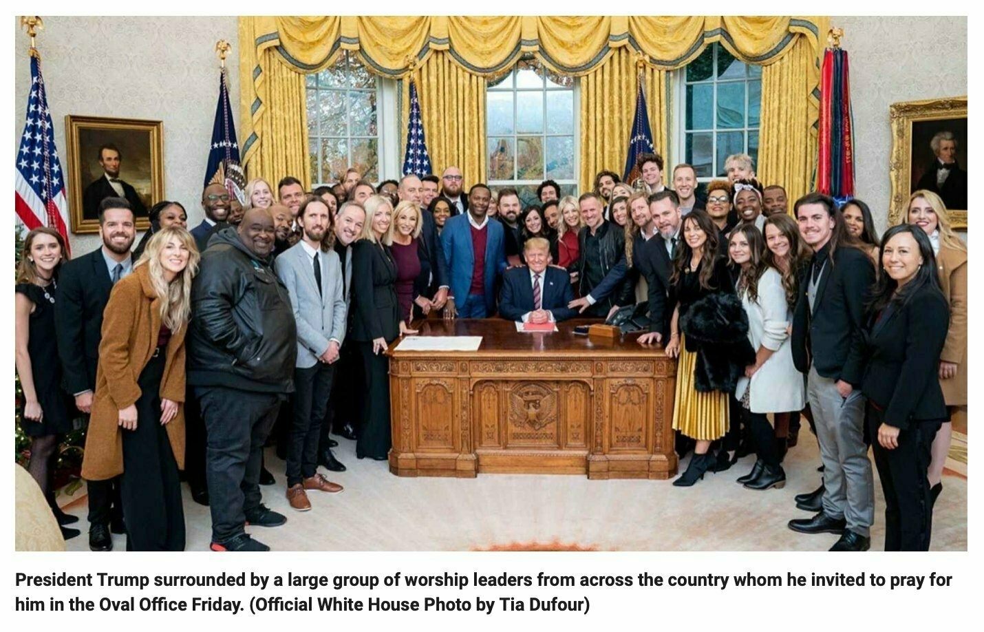 President Trump surrounded by a large group of worship leaders from across the country whom he invited to pray for him in the Oval Office Friday. (Official White House Photo by Tia Dufour)