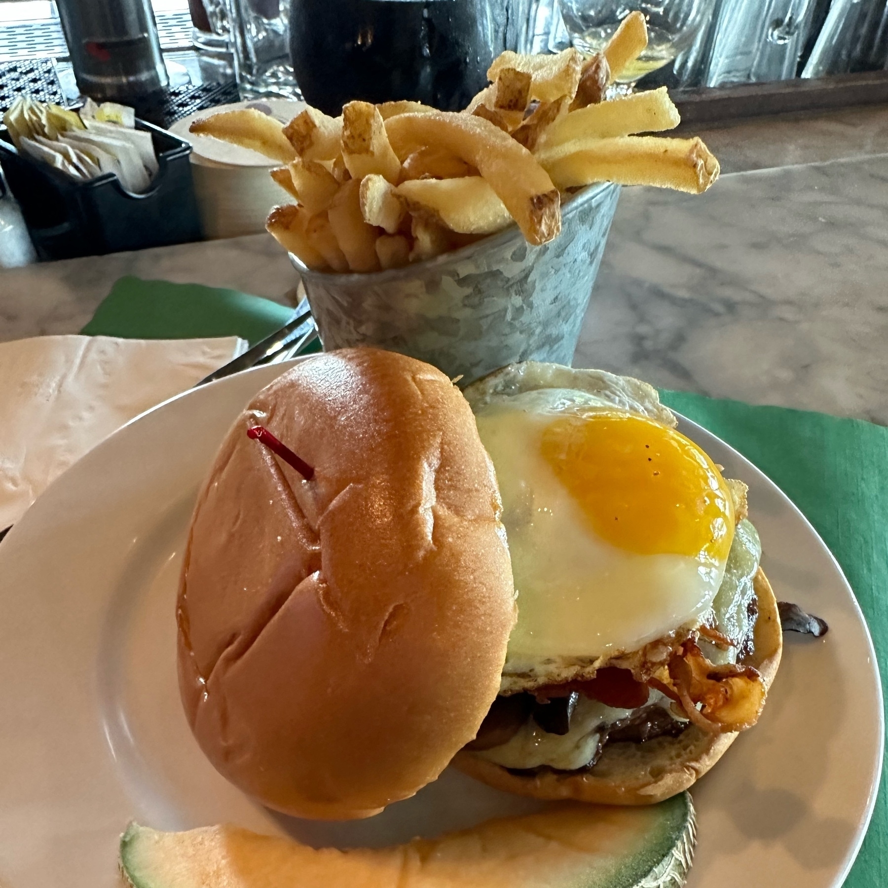 burger with an egg and fries 