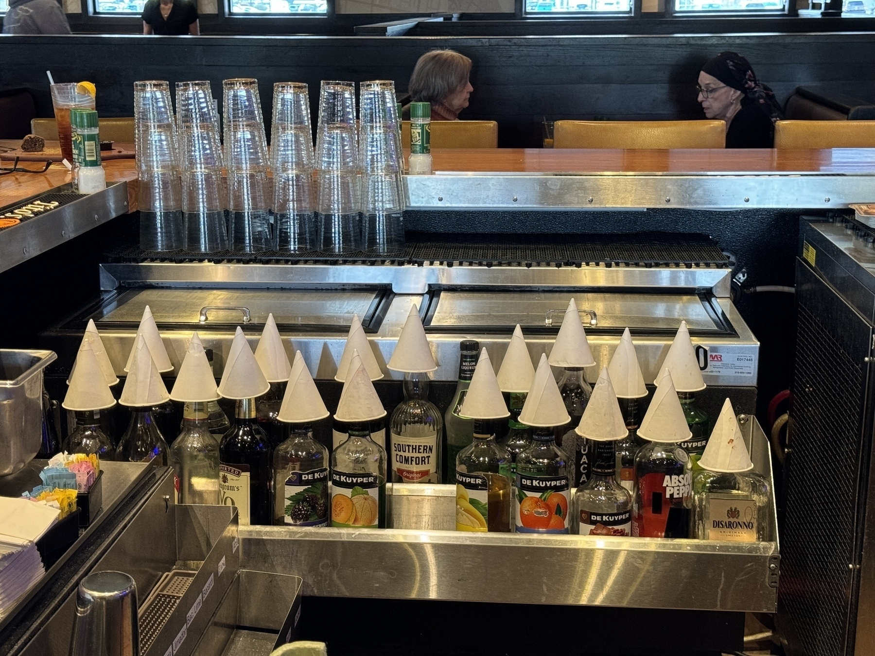 Liquor bottles with paper cone hats in a restaurant 