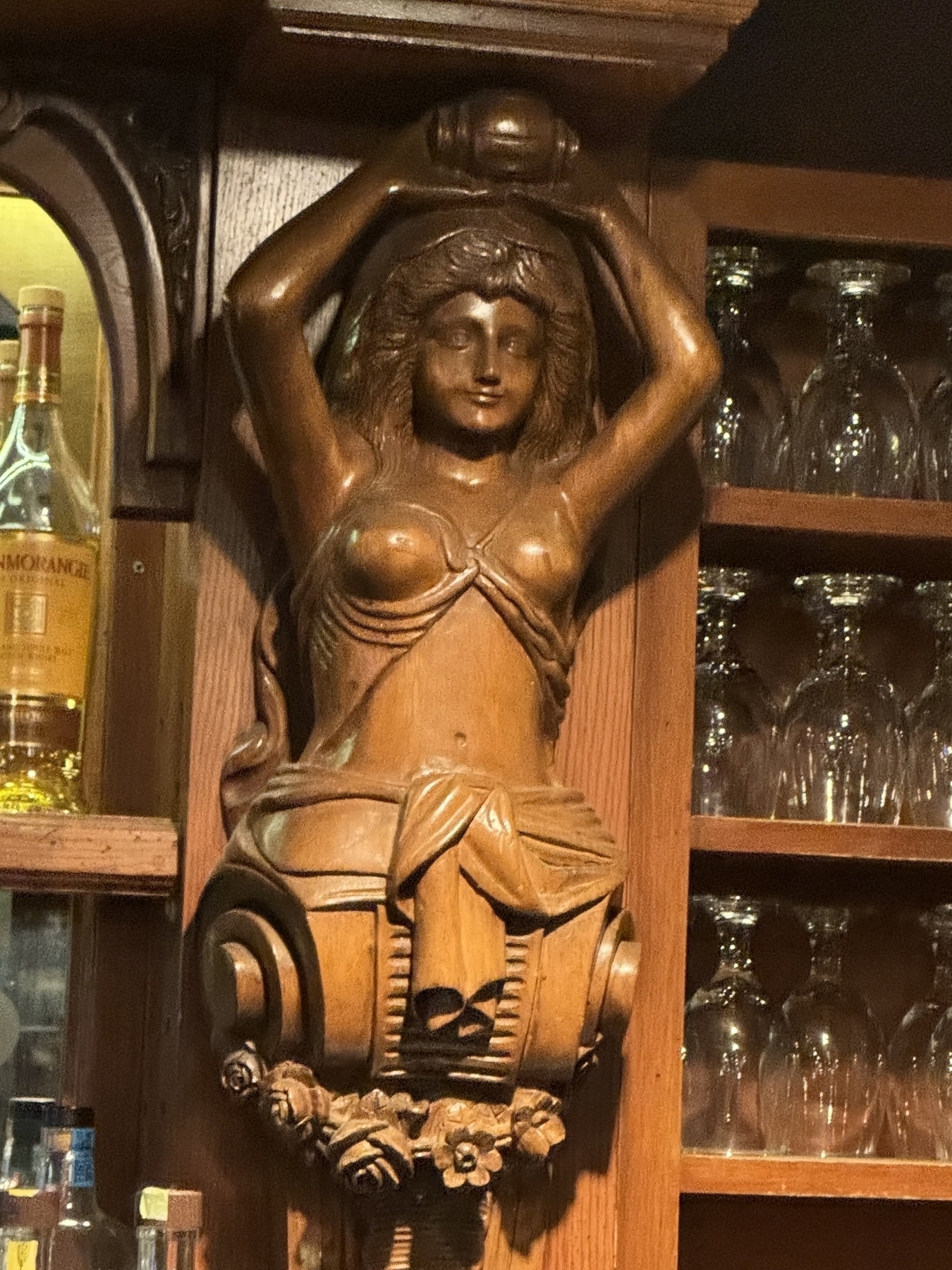 Wooden statue/maidenhead at a bar 