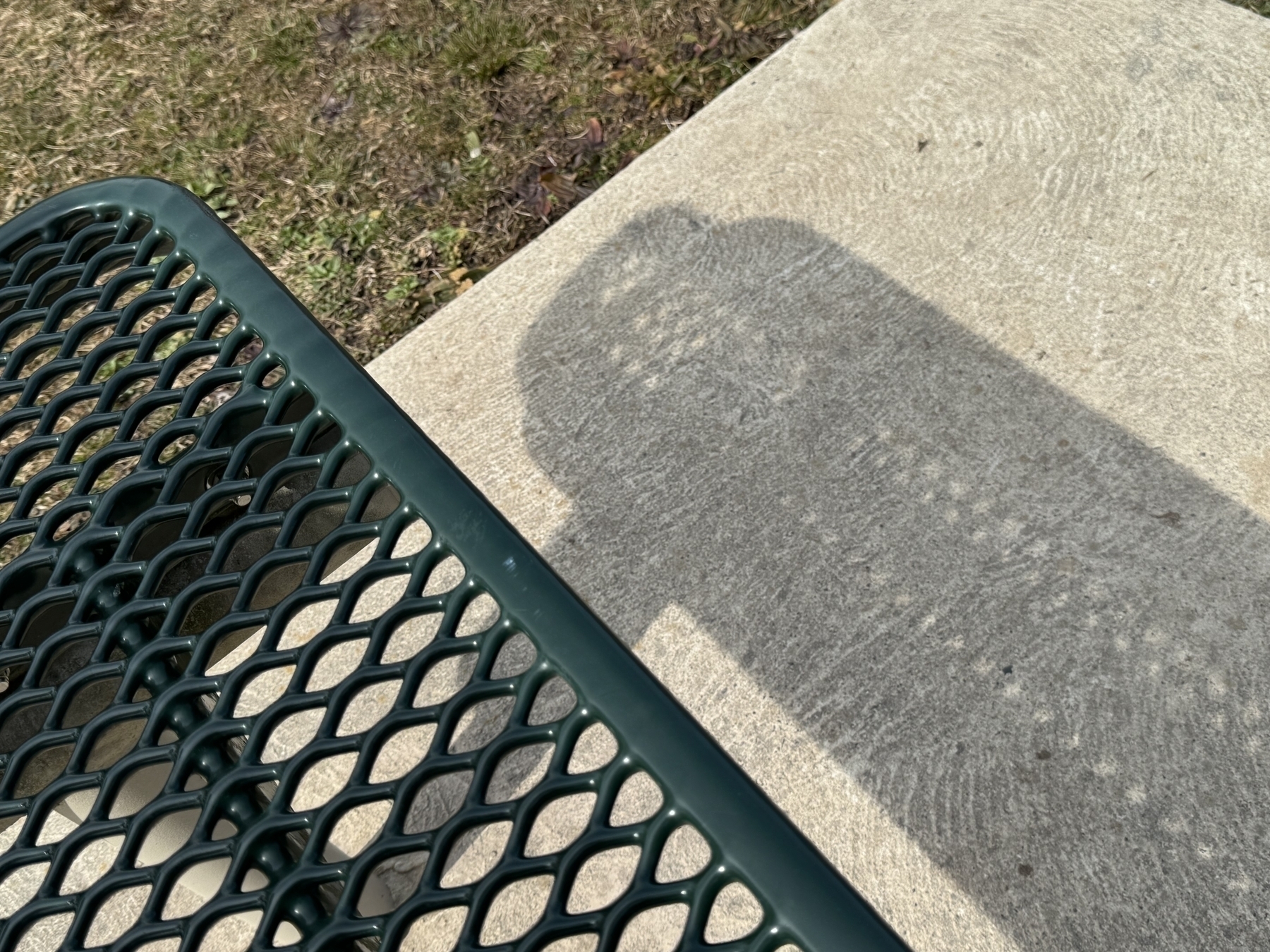 Park bench and shadow. 