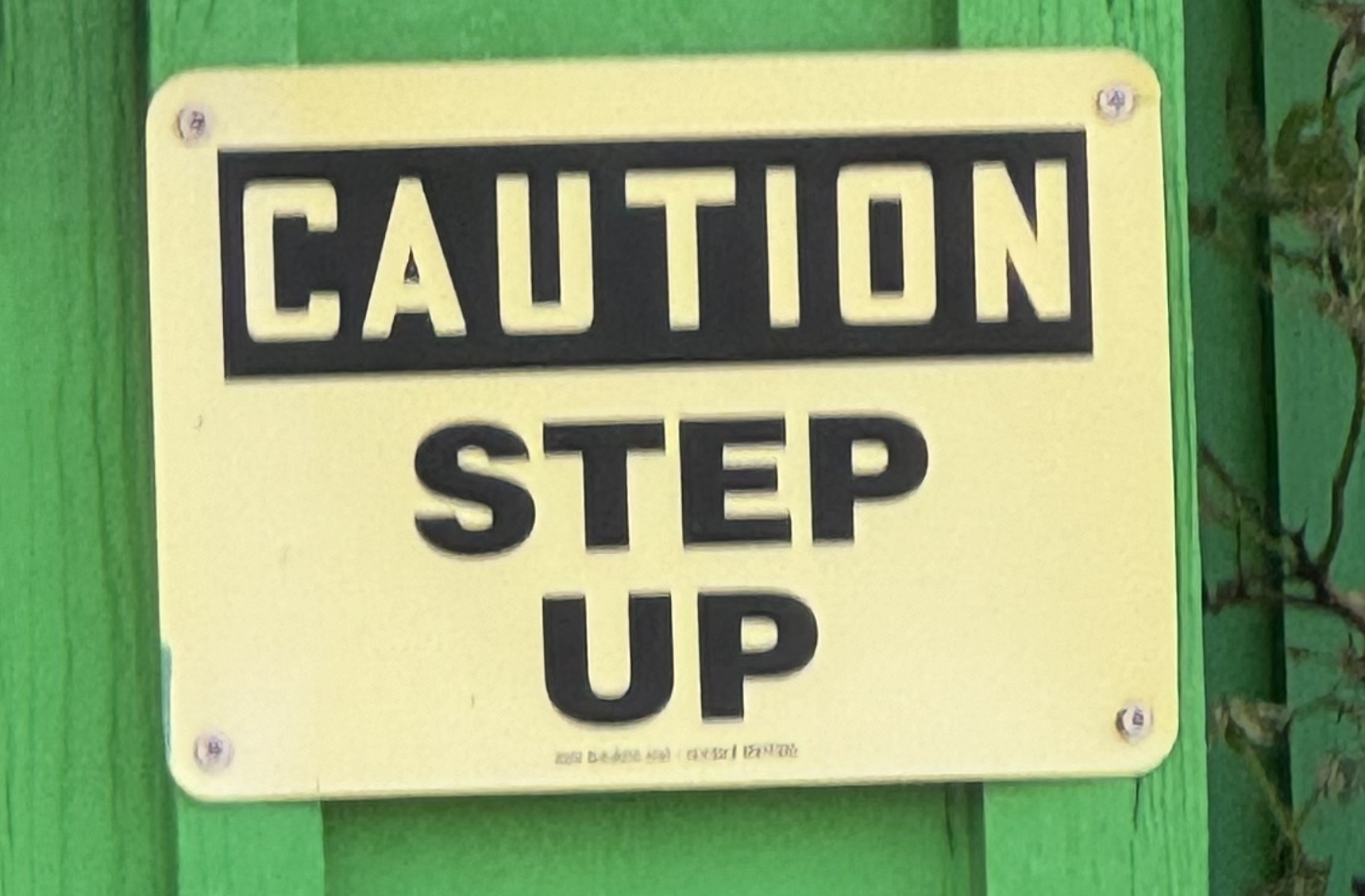 Sign that reads, “Caution: Step Up”