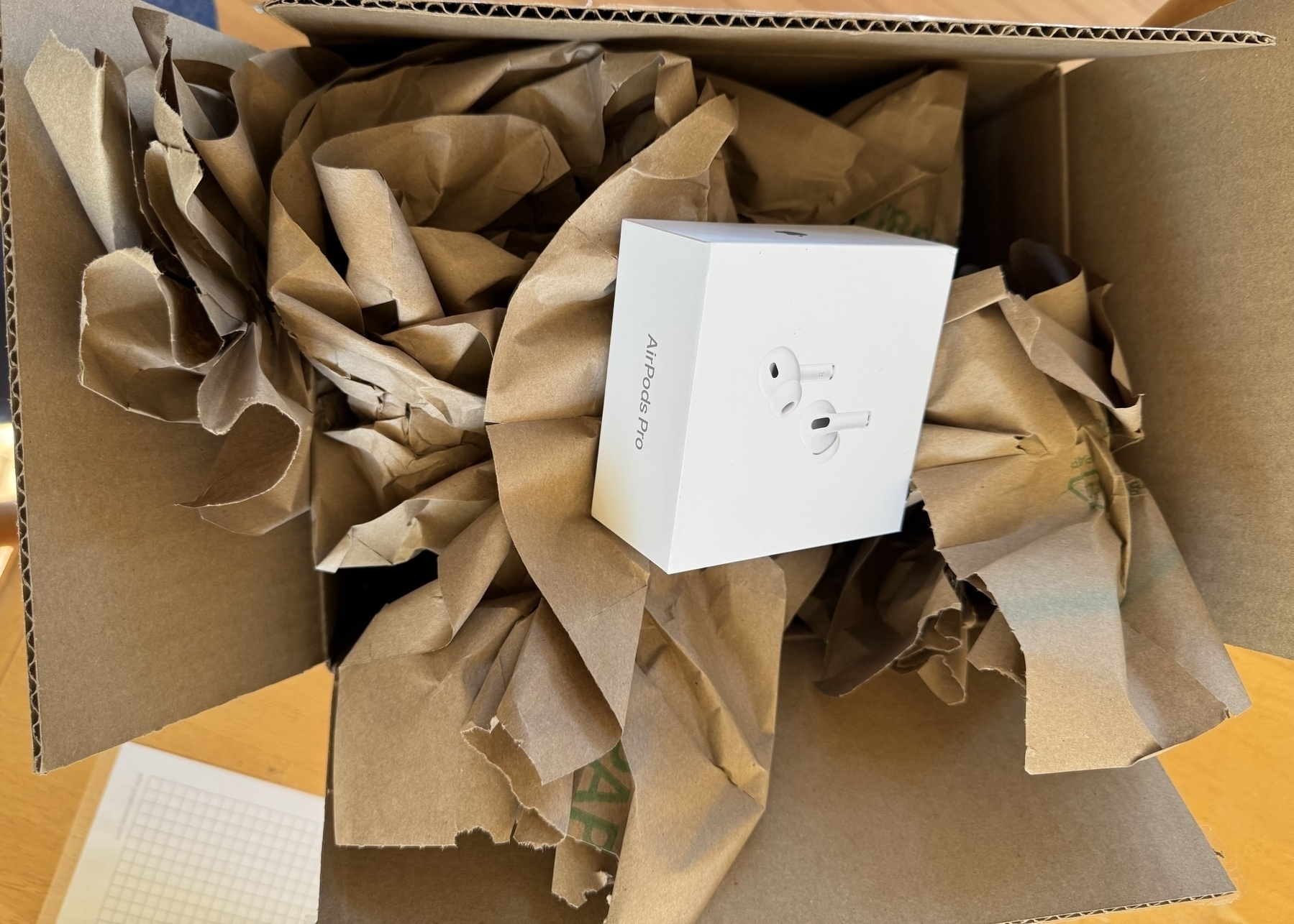 AirPods in oversize and overpacked box.