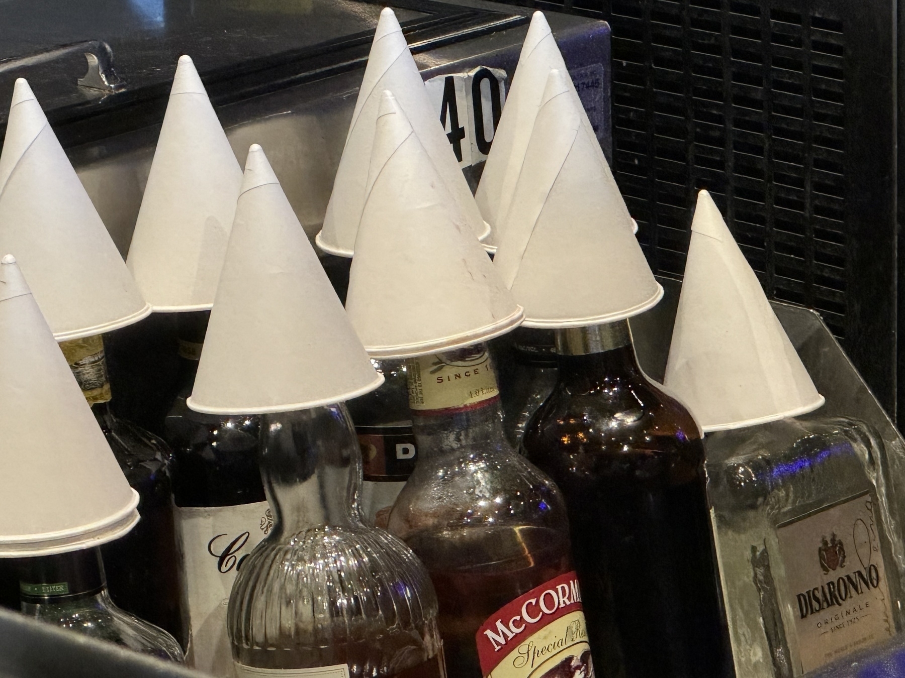 Bottles with paper cup hats. 