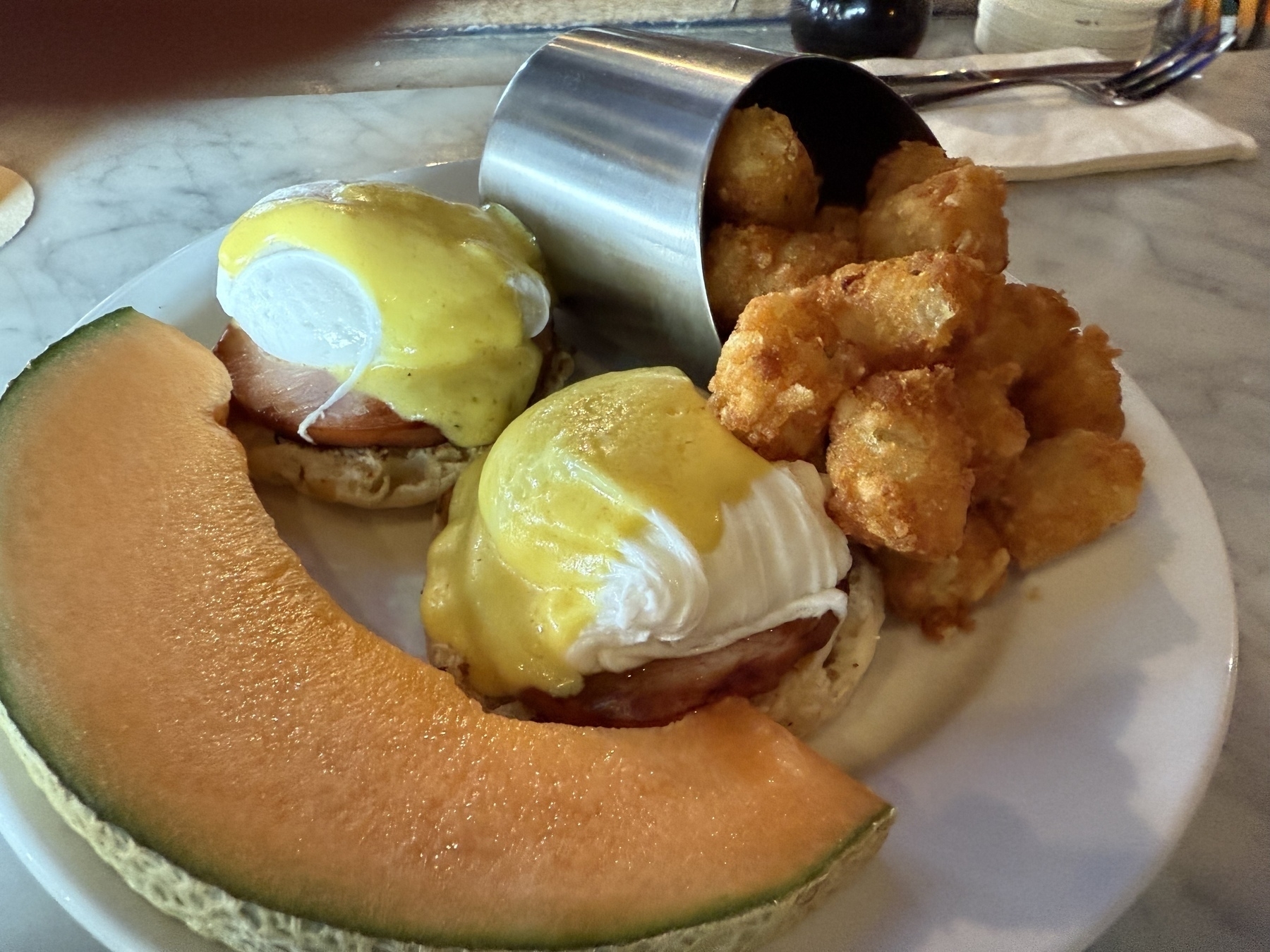 Eggs Benedict, tater tot’s, cantaloupe 