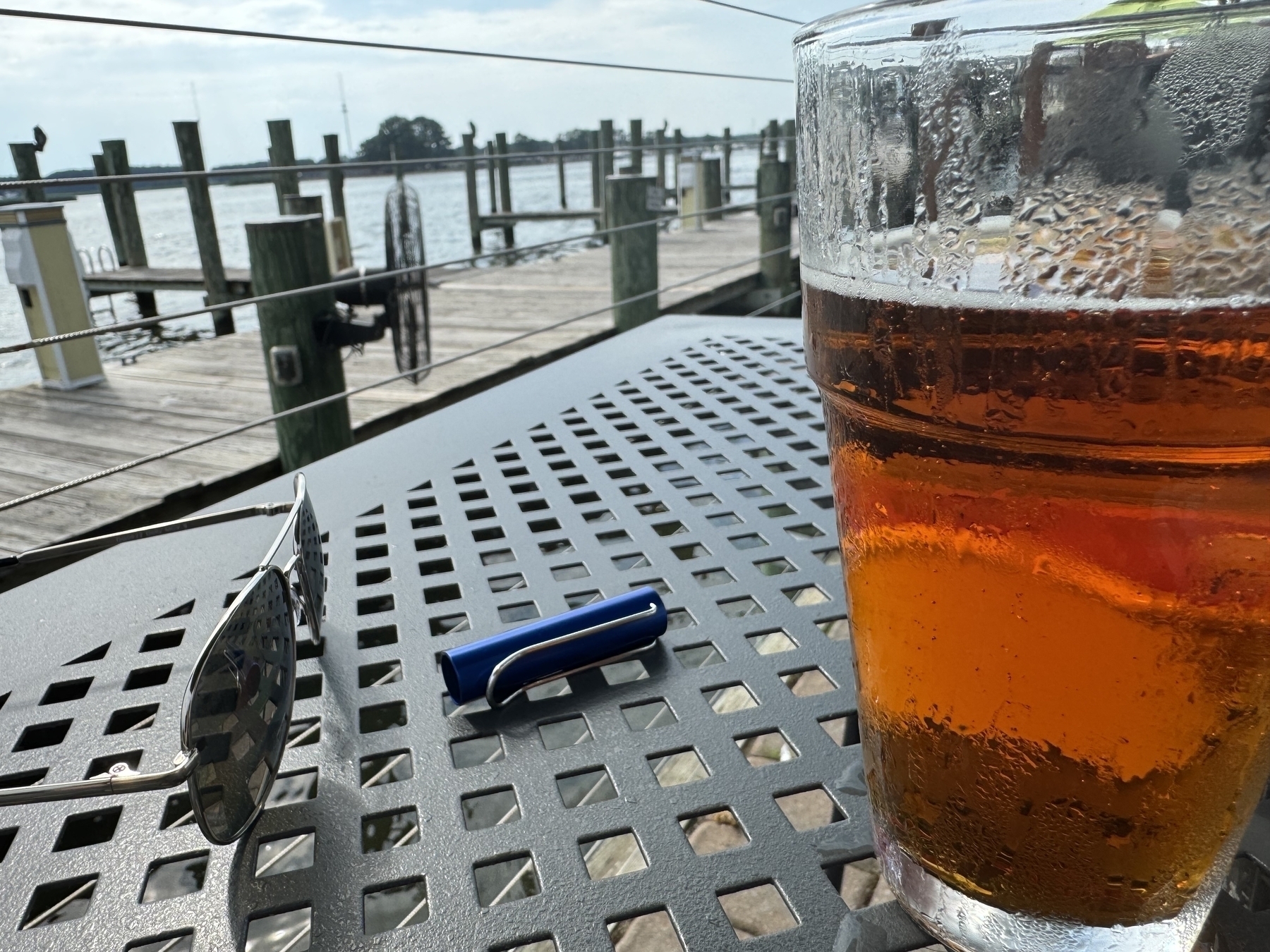 Sunglasses, piers, Lamy pen top, and a beer. 