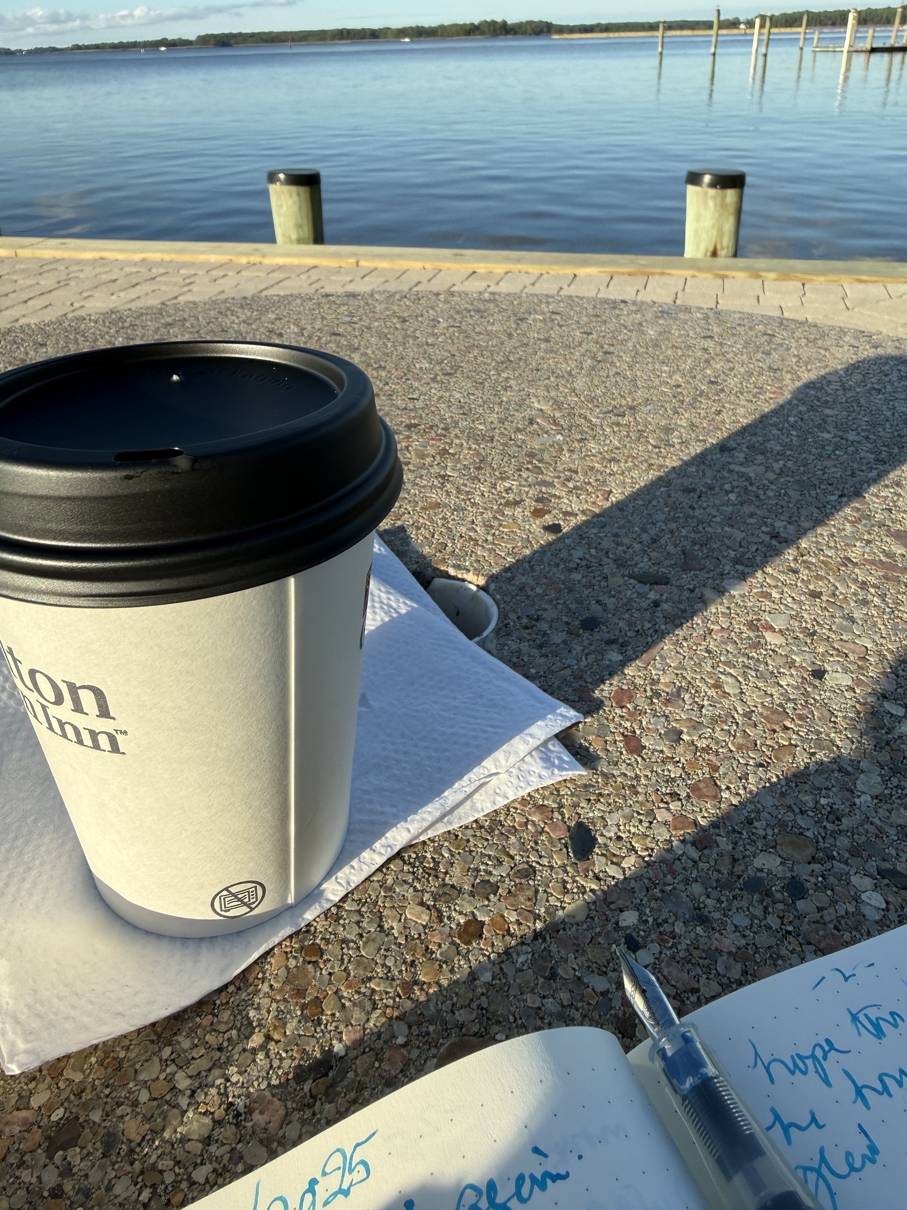Coffee, notebook, fountain pen, and view   