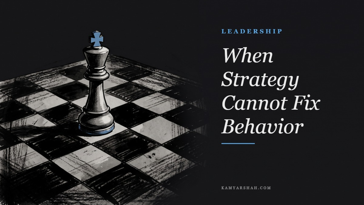 Social card for kamyarshah.com: "When Strategy Cannot Fix Behavior", flat-design graphic, split layout, forest palette, warning motif.