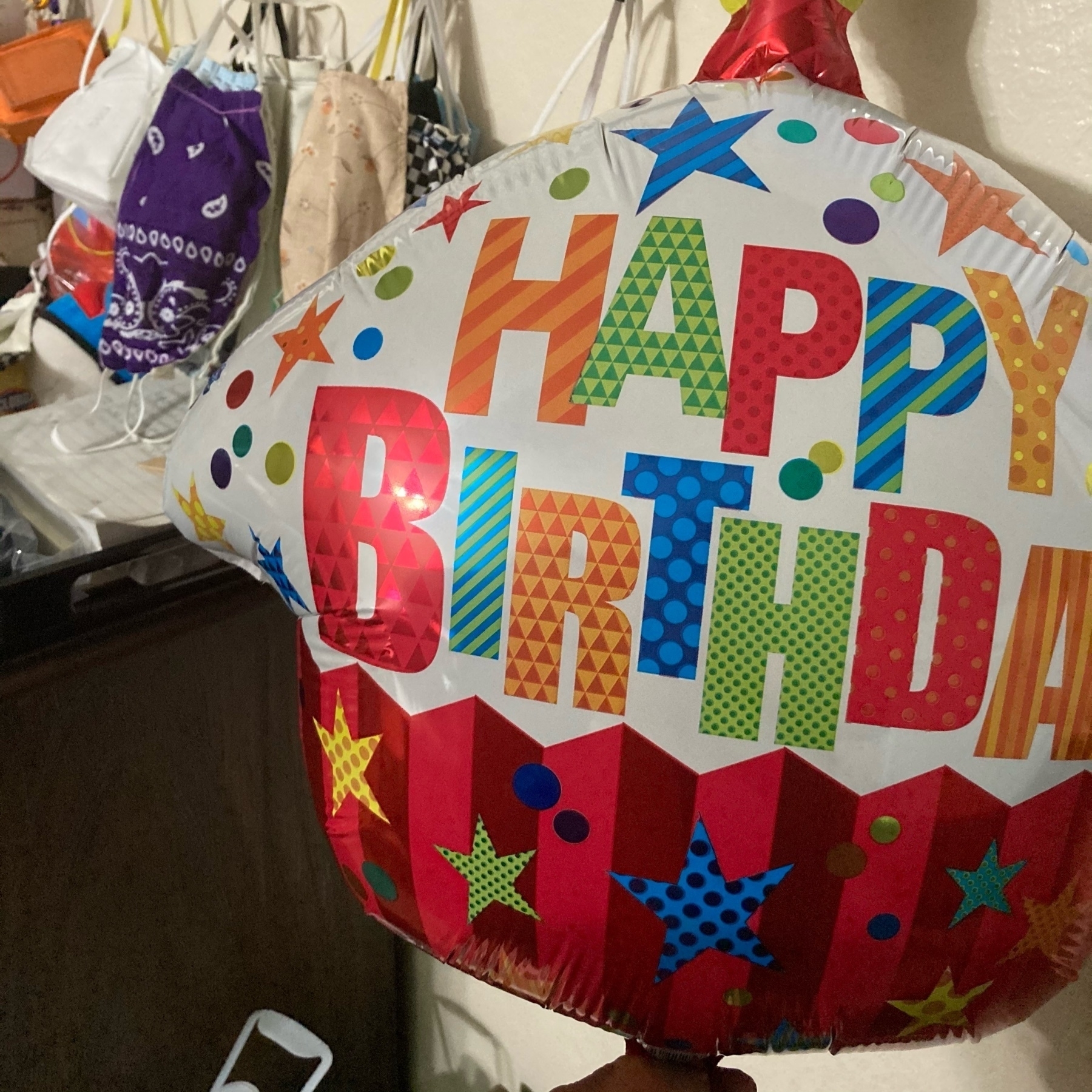 Birthday ballon next to masks. 