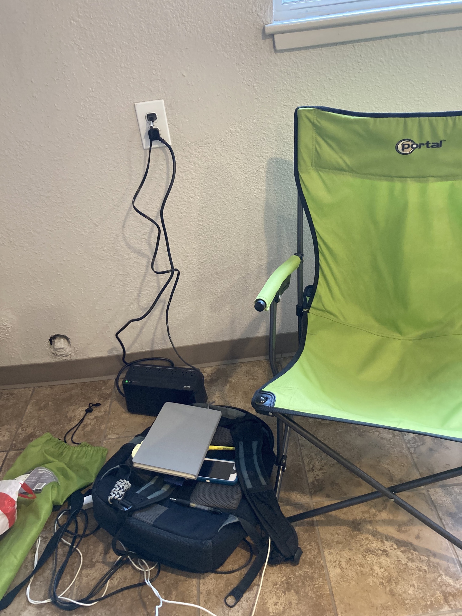 A chair next to iPhones being charged. 