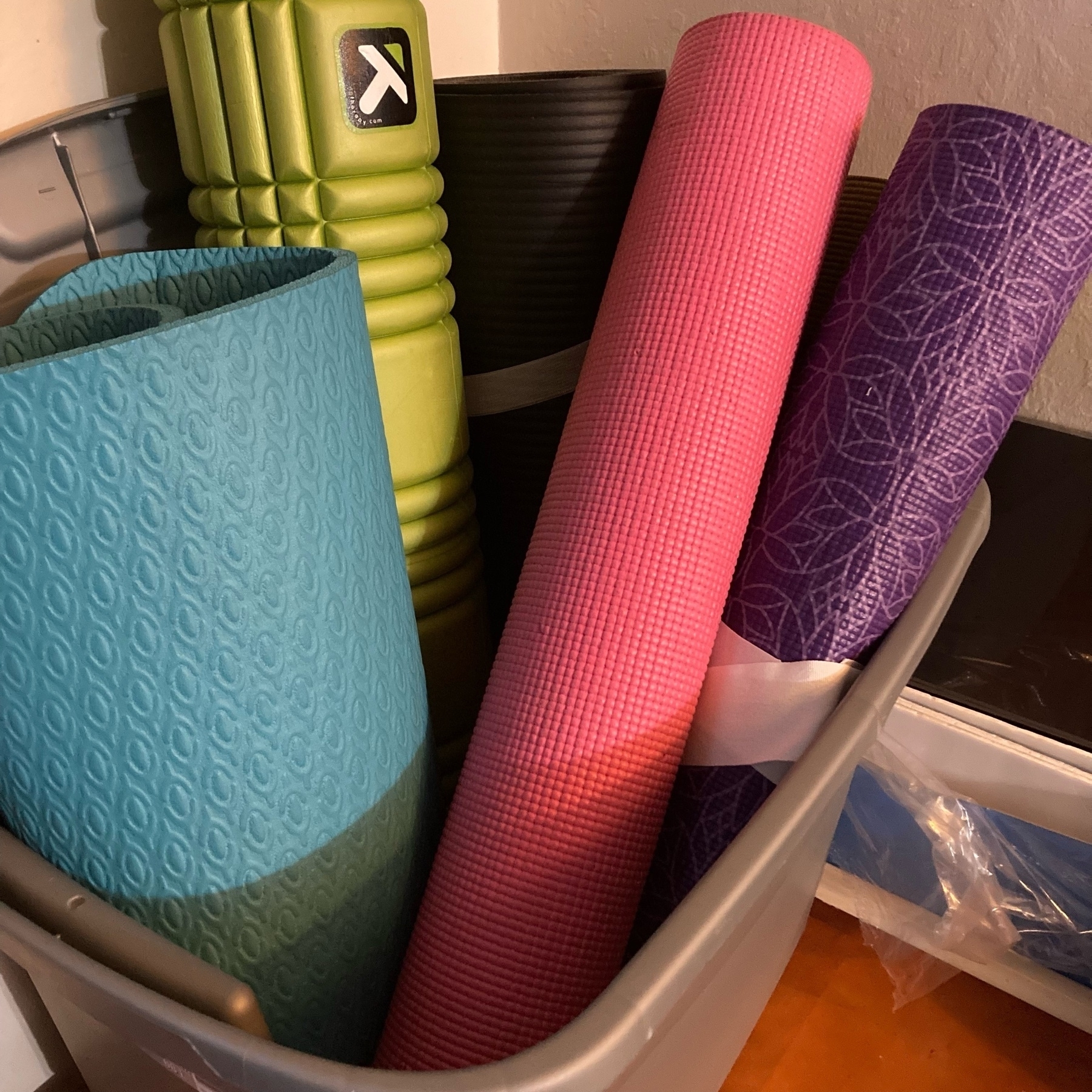 Yoga mats in a bin. 