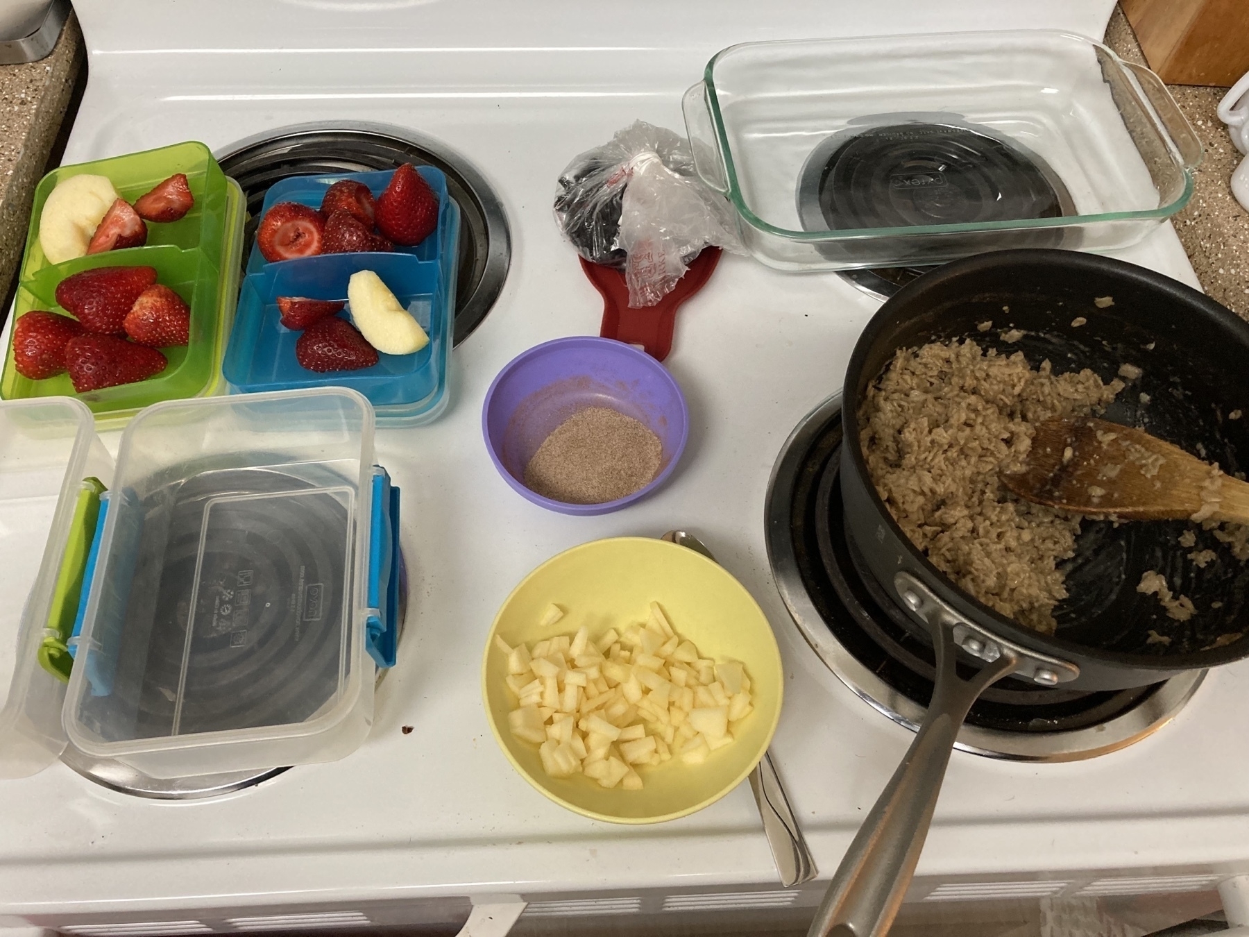 Stove with oatmeal and fruit on top. 