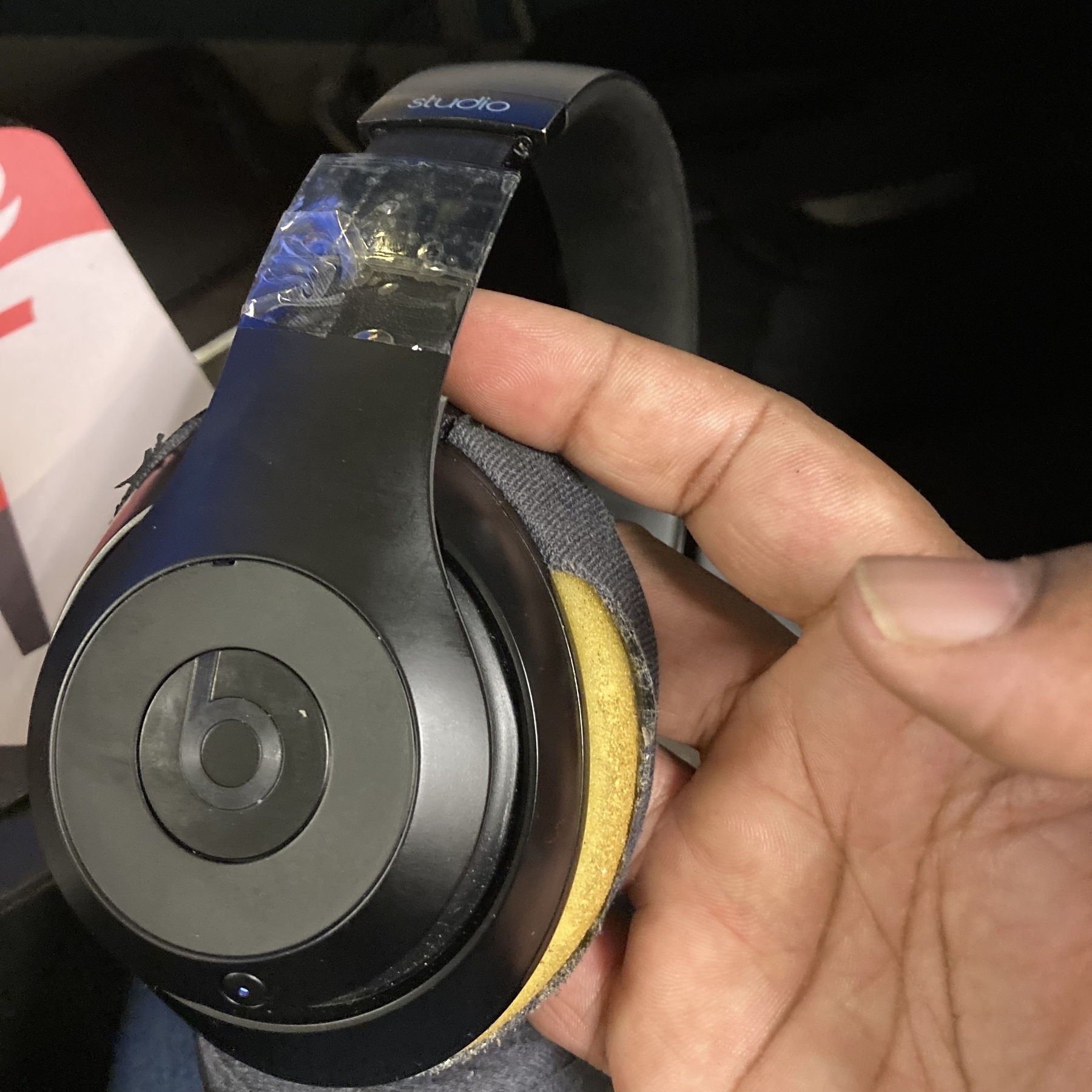 Beat headphones with tape and ripped padding. 