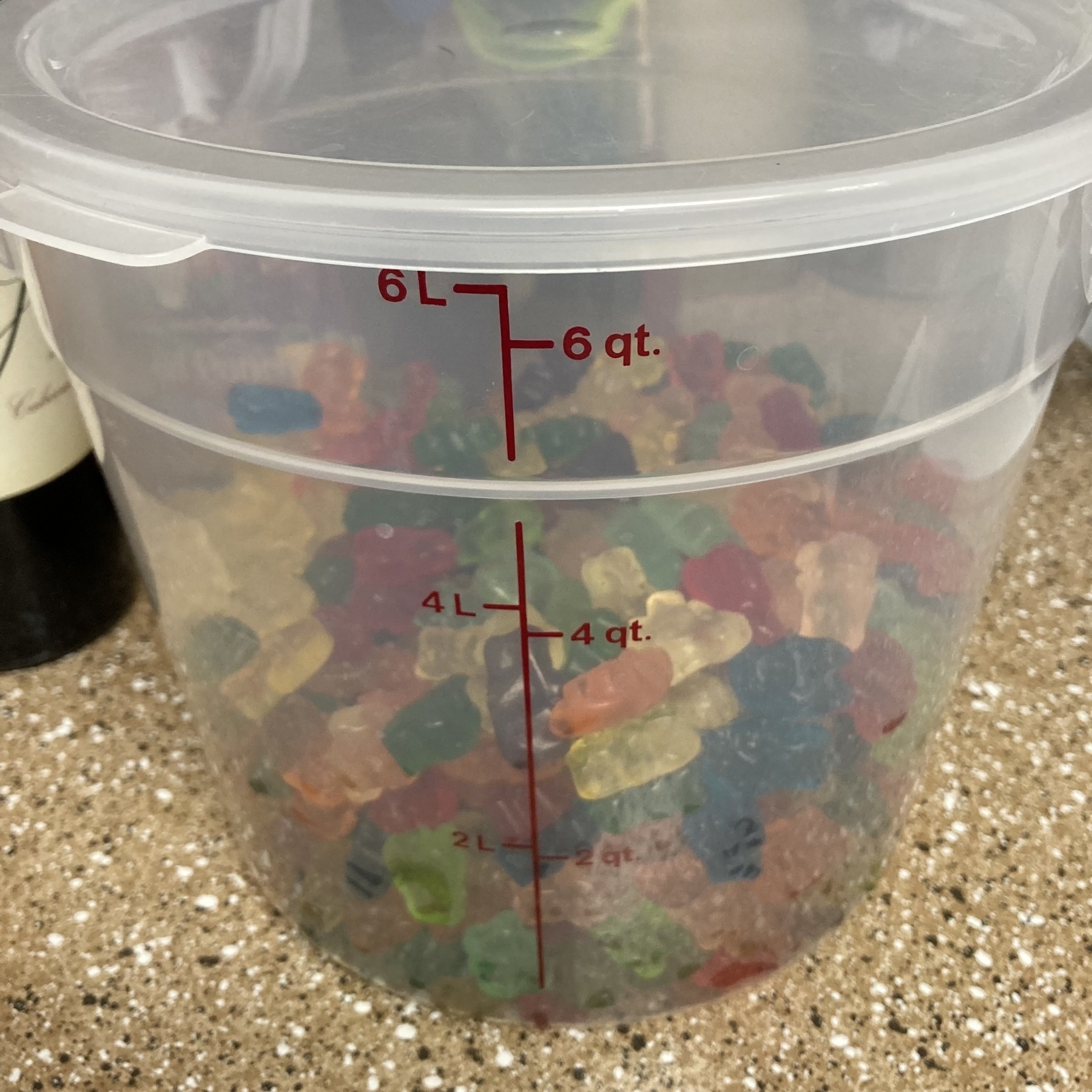 4 quarts of gummy bears in plastic container. 