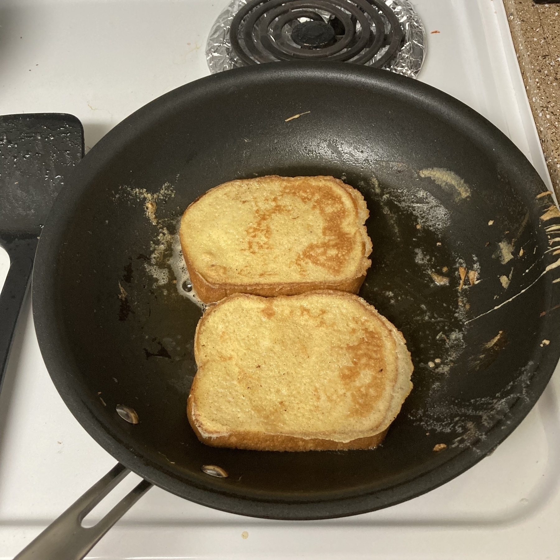 French toast in cooking in the pan. 