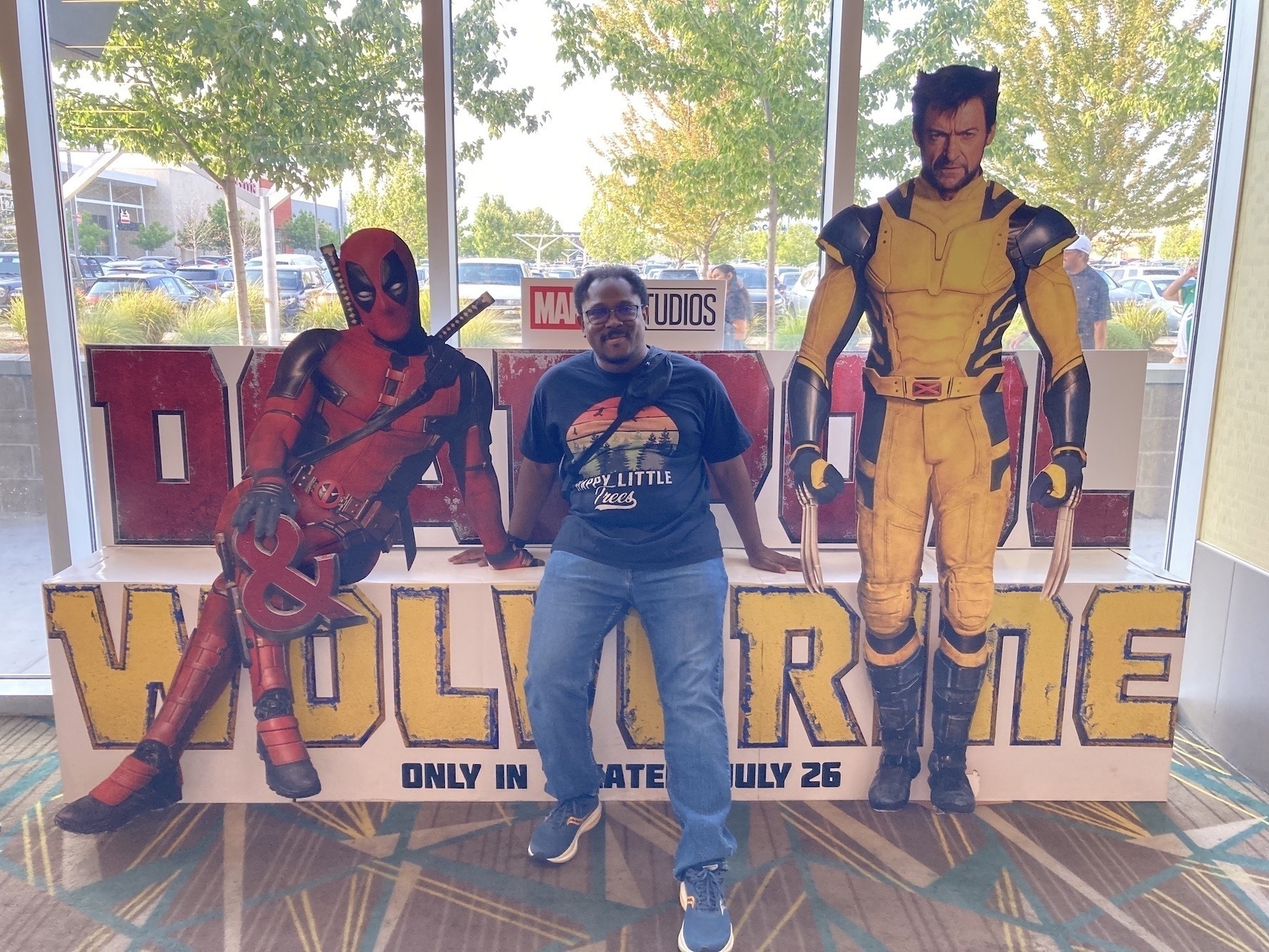 Me sitting on a movie display for Deadpool and Wolverine