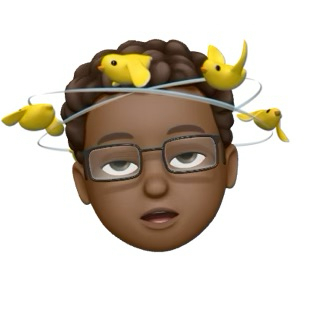 Auto-generated description: Four yellow birds are perched around a ring above the head of a digital avatar with brown skin, curly hair, and glasses.