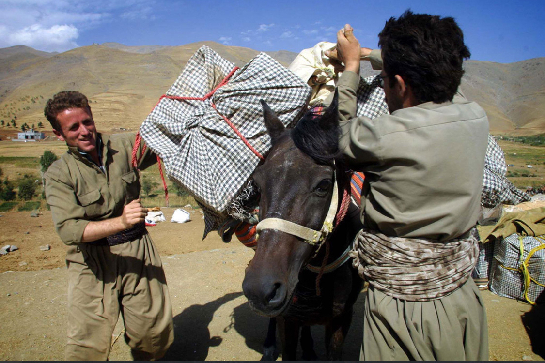 Kurdish smugglers load cigarettes onto a horse for illegal entry into Iran in October 2002. Source: Reuters