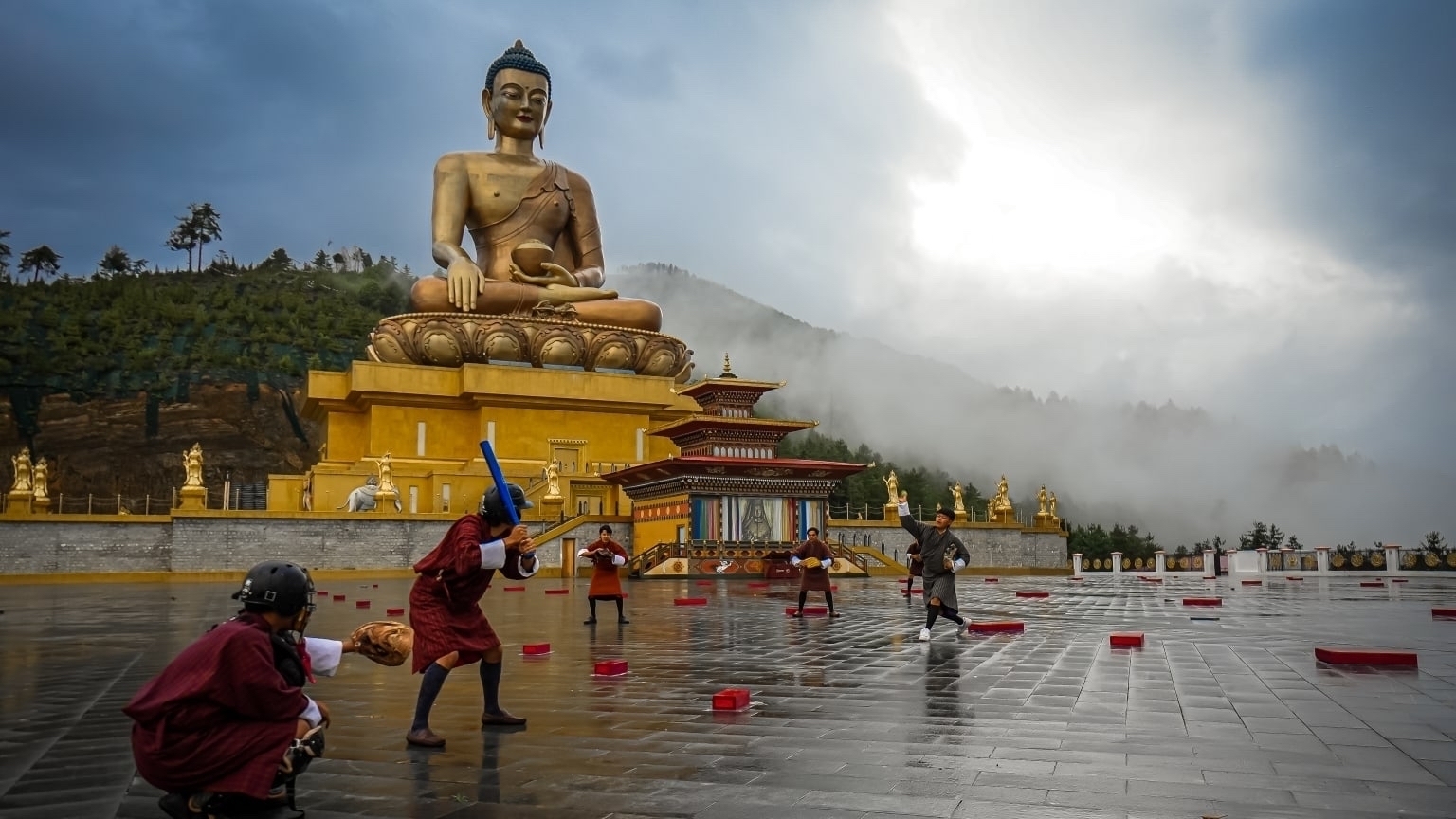 Baseball being played in front of the Great Buddha Dordenma statue in Thimphu, Bhutan. 