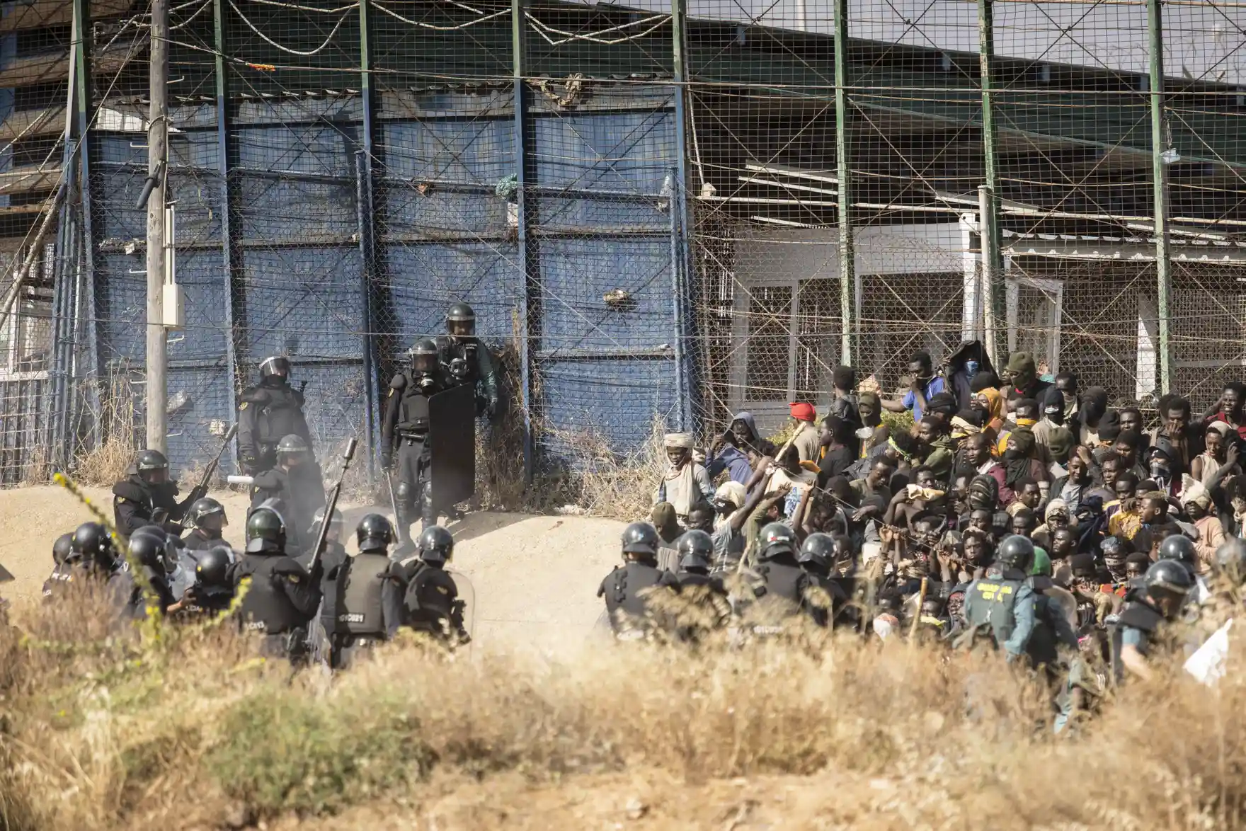 Riot police detain people at the Barrio Chino border crossing between Morocco and Melilla on 24 June 2022. Photograph: Javier Bernardo/AP