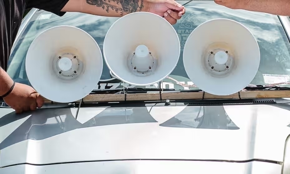 Three loud hailers mounted to a car