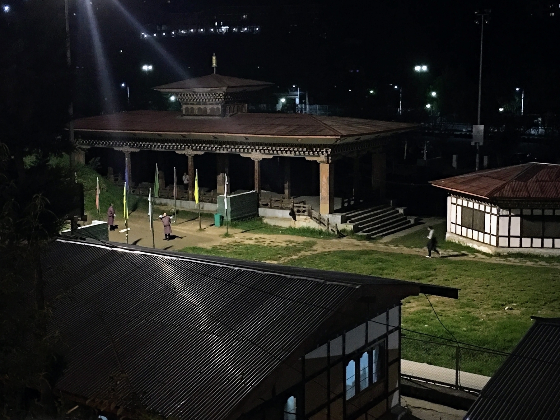 A man practicing archery at night on a long distance range. A photo I took when I was in Bhutan. 