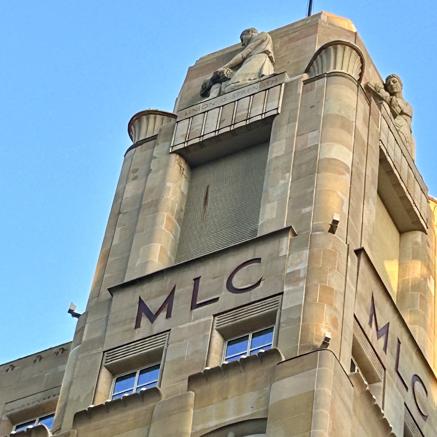 Closer view of the top of the building. It says MLC. 