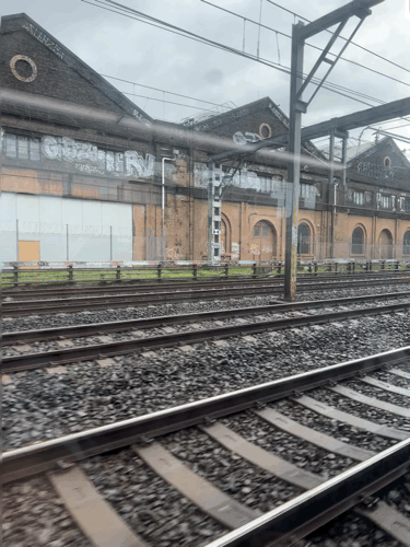 View from a train window at Redfern NSW. The speed of the train creates a strobing effect with the closest train line, making it look like the train could be moving in two separate directions. 