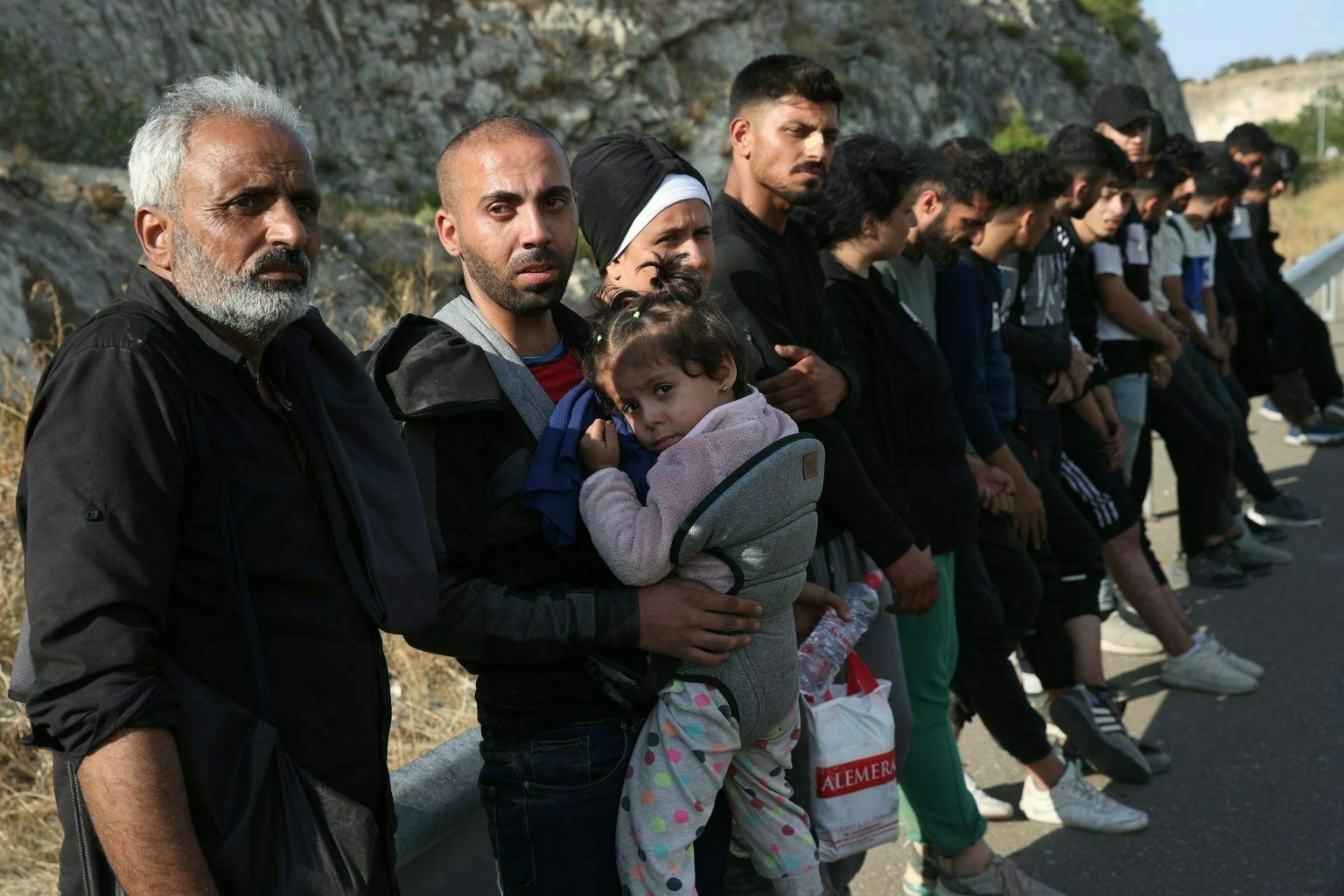  Stranded migrants wait for police officers as wildfires burn through Evros, Greece.